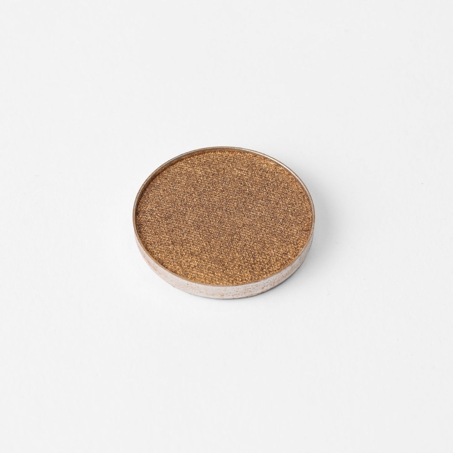 Glow Pressed Eyeshadow in shimmering pan for vibrant, buildable, vegan eye makeup.