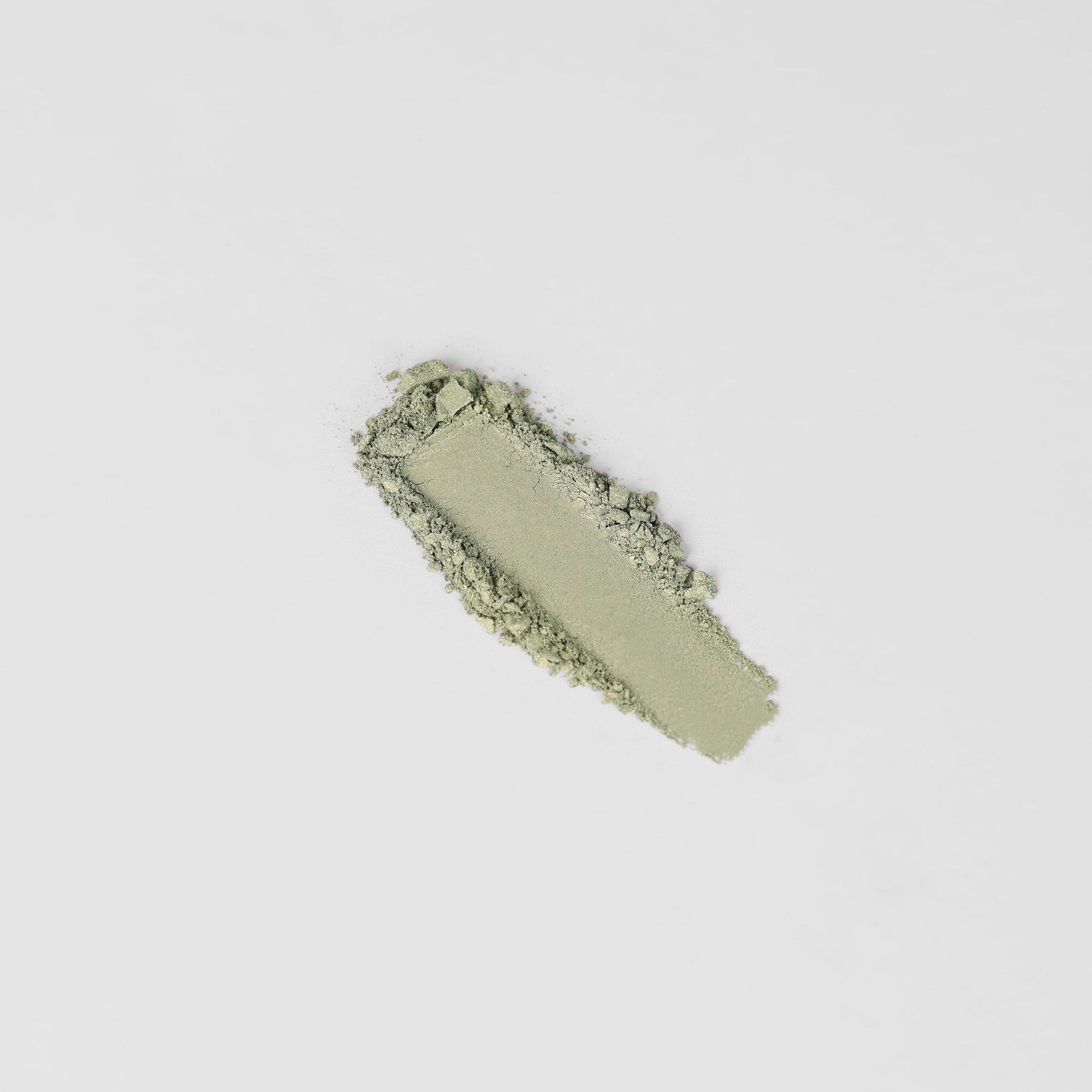 Glow Pressed Eyeshadow in light green shade on white background for luminous eye makeup application