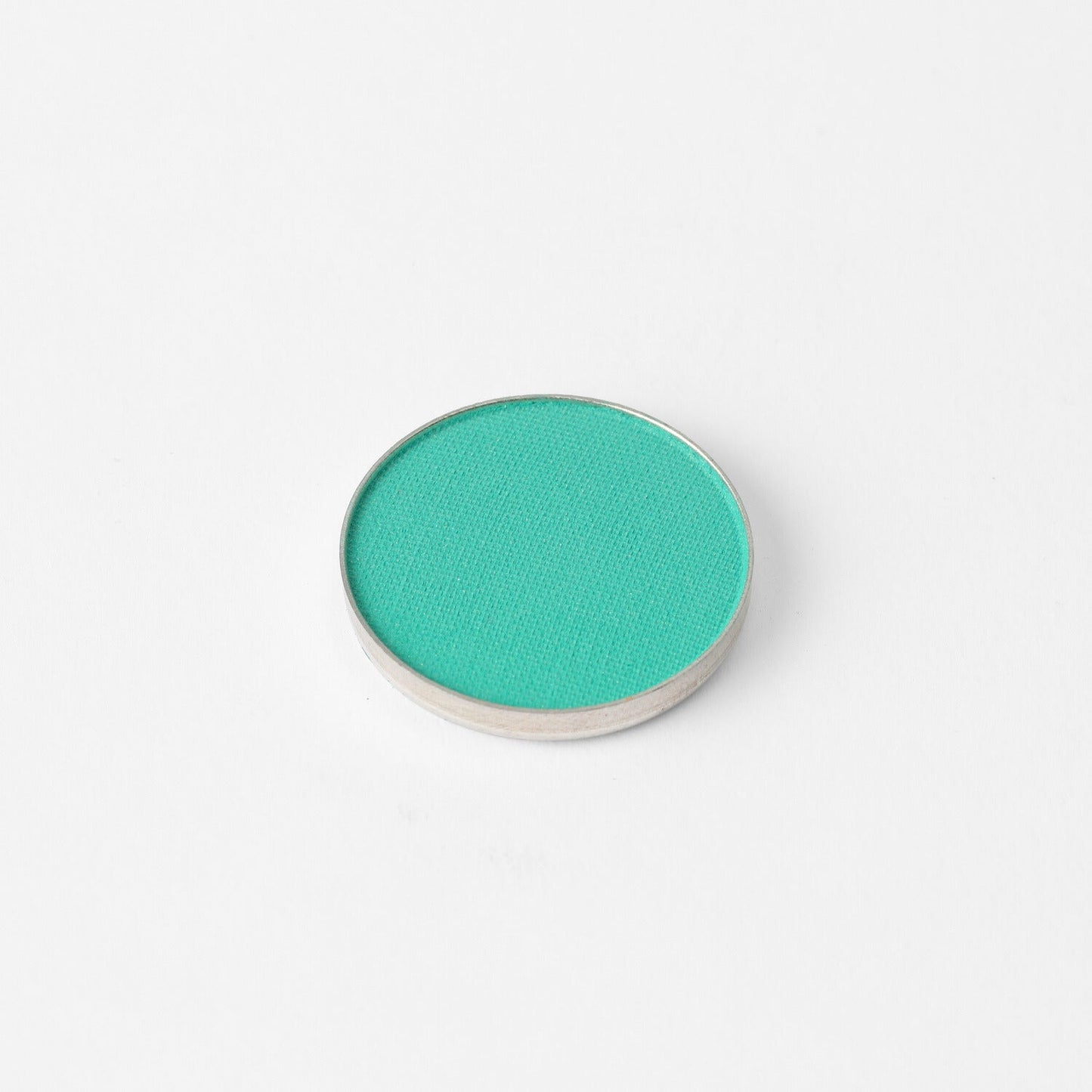 Glow Pressed Eyeshadow single pan in teal, rich vegan pigment for luminous and buildable color