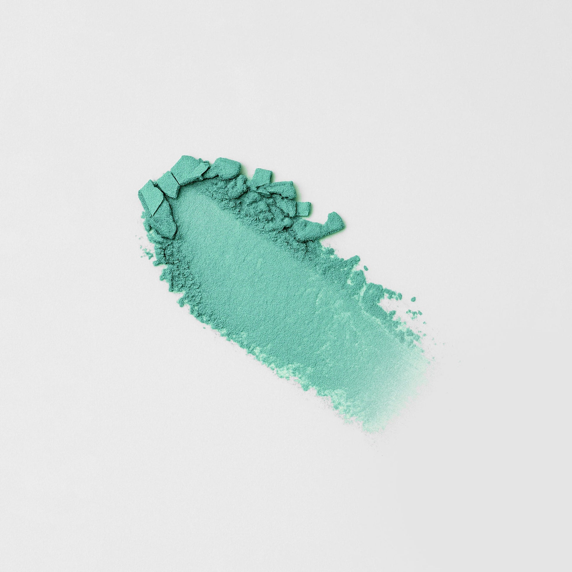 Glow Pressed Eyeshadow in teal color swatch on white background showcasing its smooth, blendable texture and vibrant pigments.