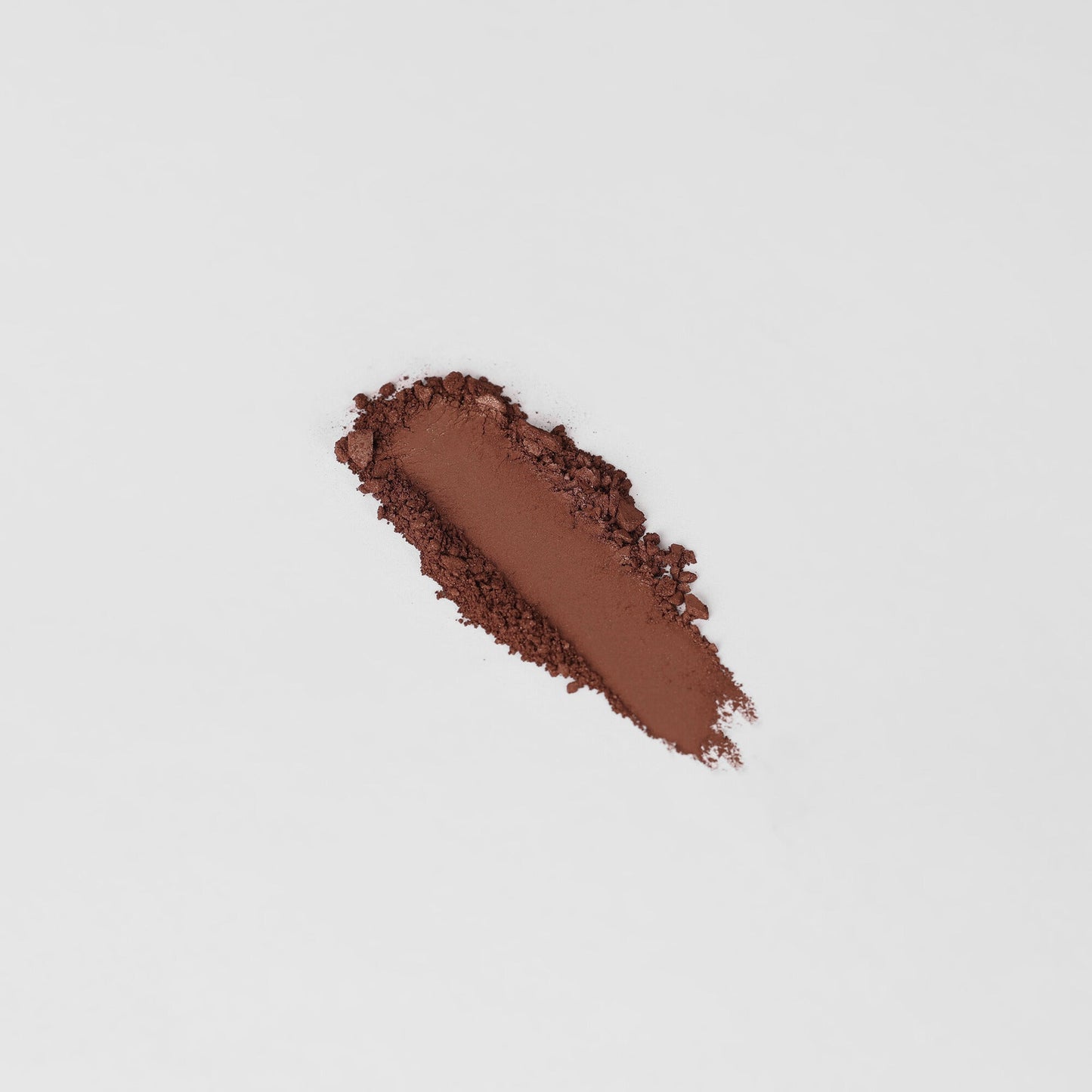 Rich brown Glow Pressed Eyeshadow swatch on a white background, showcasing smooth texture and luminous pigment.