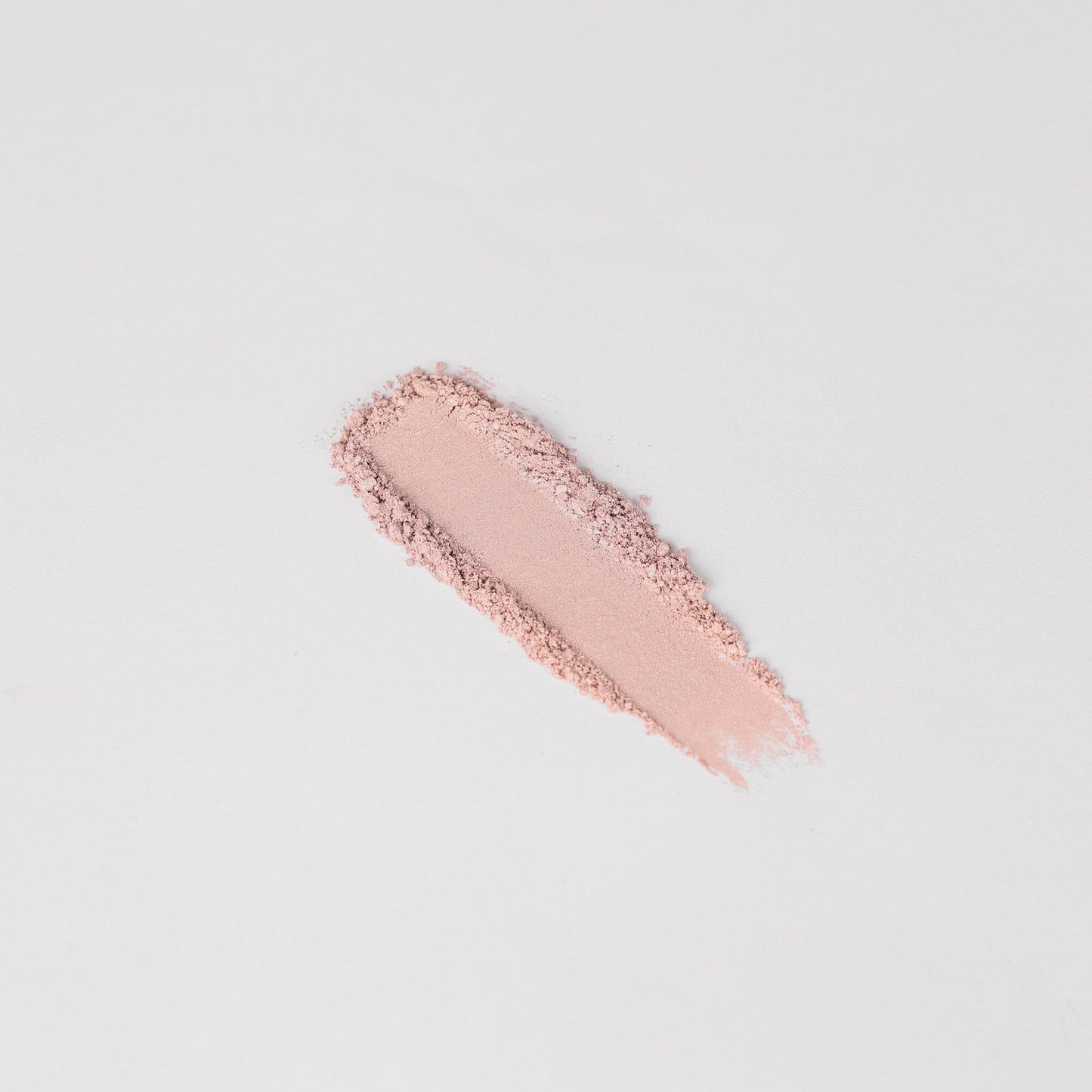 Swatch of Glow Pressed Eyeshadow showing soft pink shimmer on a white background.