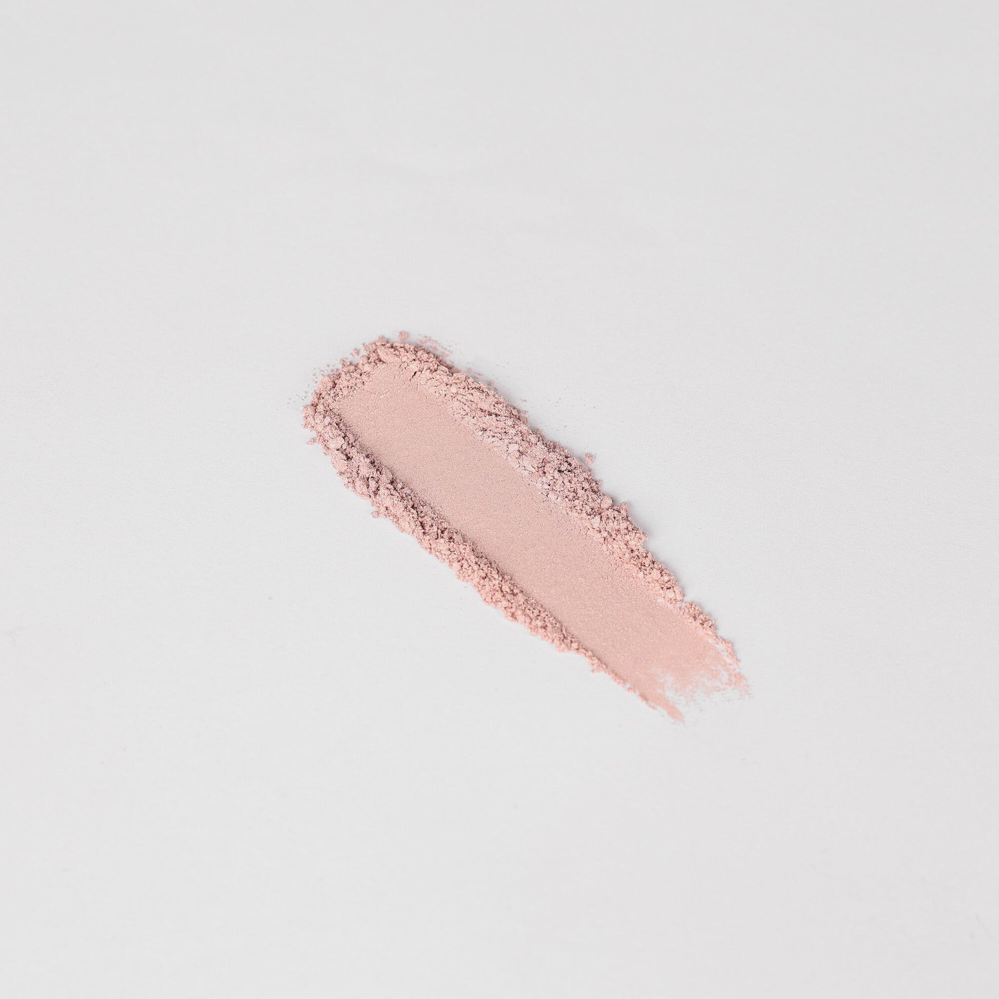 Swatch of Glow Pressed Eyeshadow showing soft pink shimmer on a white background.