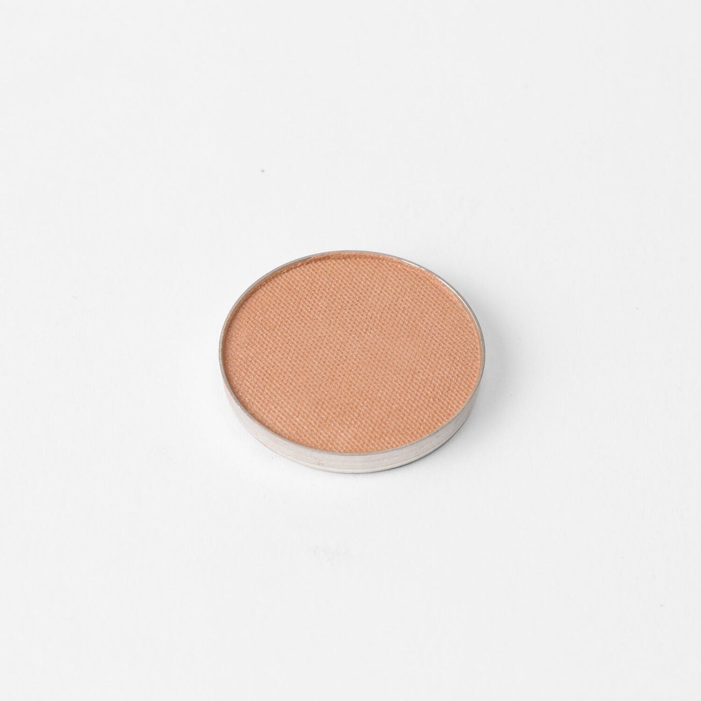 Glow Pressed Eyeshadow single pan on white background, showcasing luminous vegan pigments for a buildable, lasting glow.