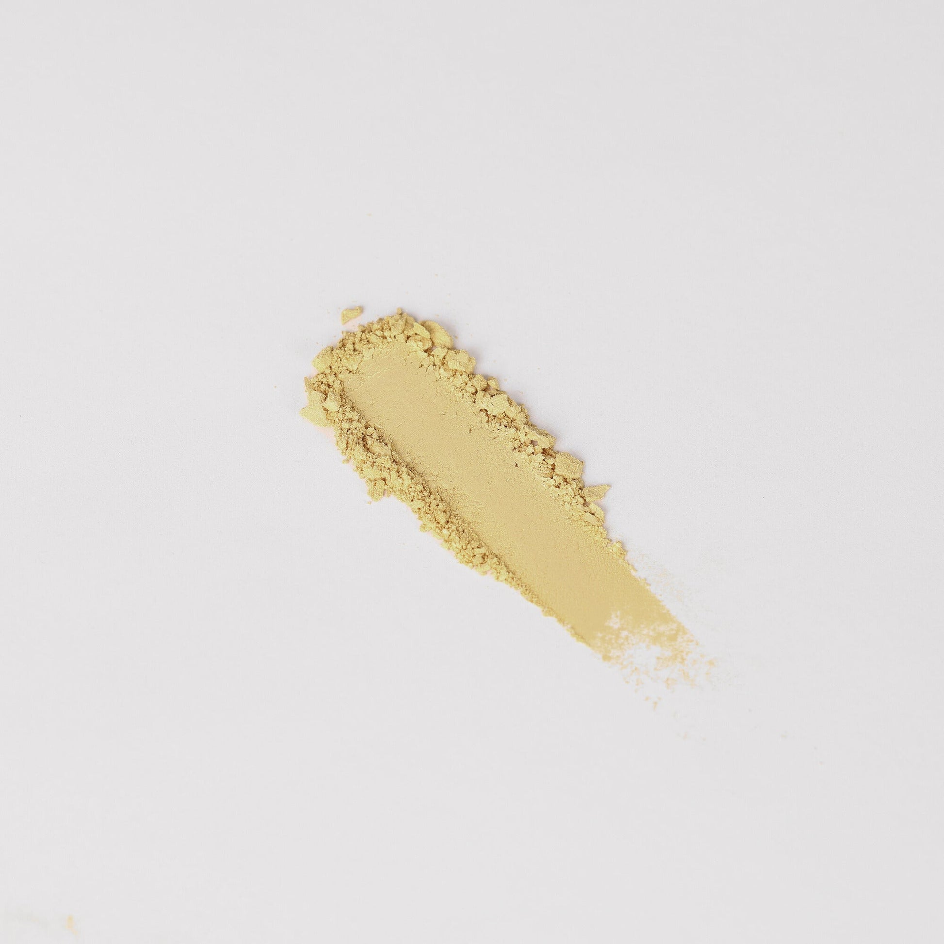 Glow Pressed Eyeshadow swipe showcasing luminous vegan pigments in a yellow shade, perfect for soft shimmer and defining eyes.