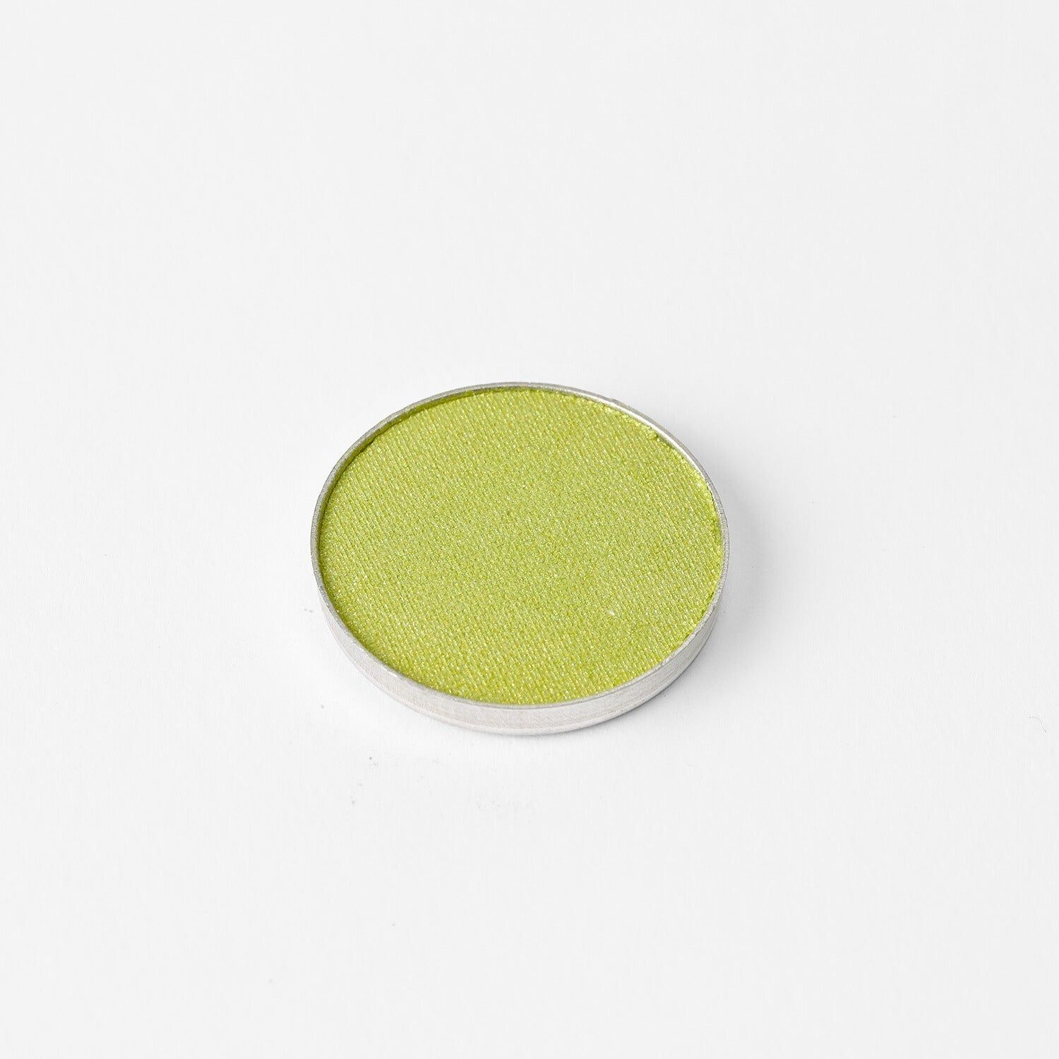 Glow Pressed Eyeshadow in a luminous green pan, providing rich vegan pigments for a smooth, blendable, and long-lasting finish.