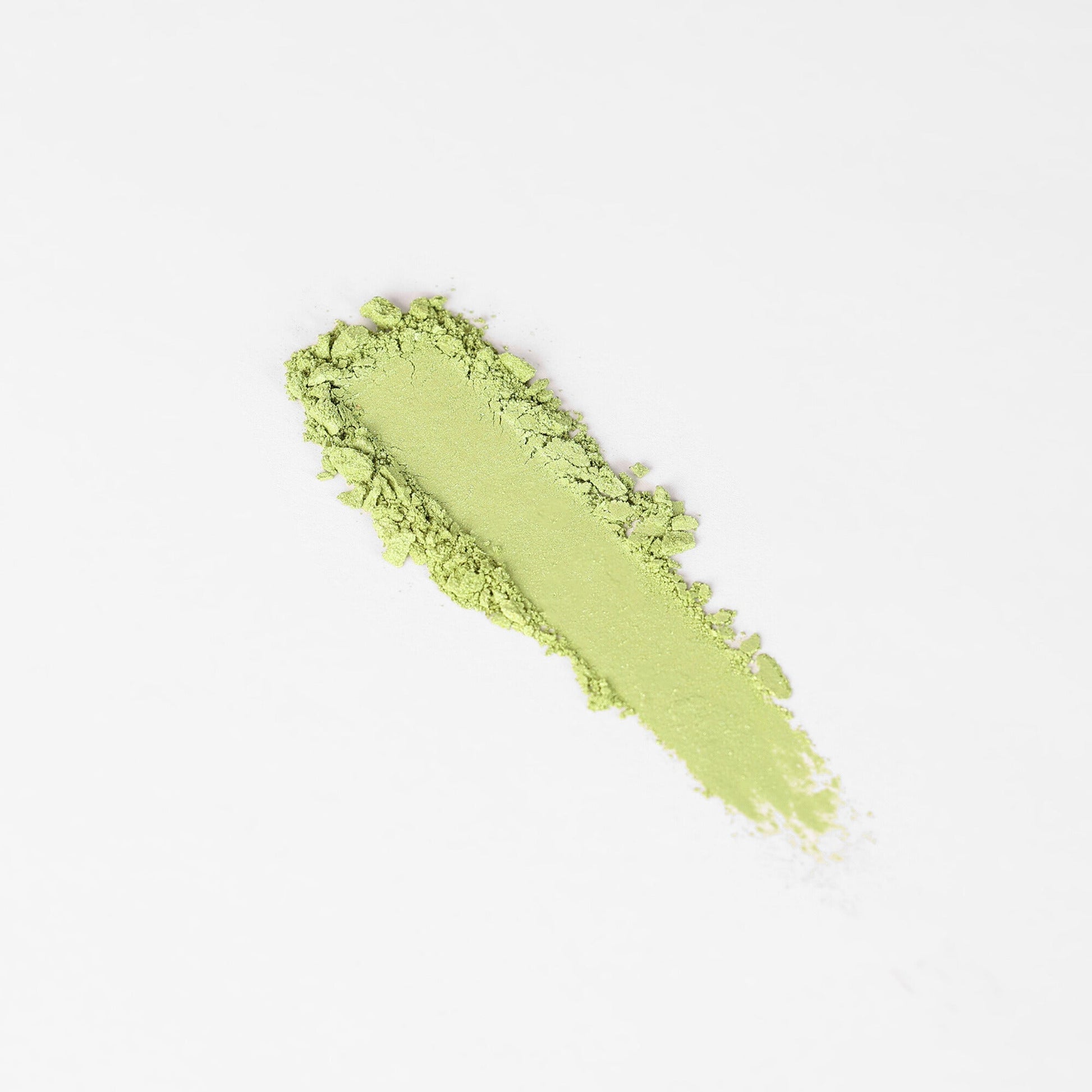 Glow Pressed Eyeshadow in lime green swatch showing smooth texture and vibrant color
