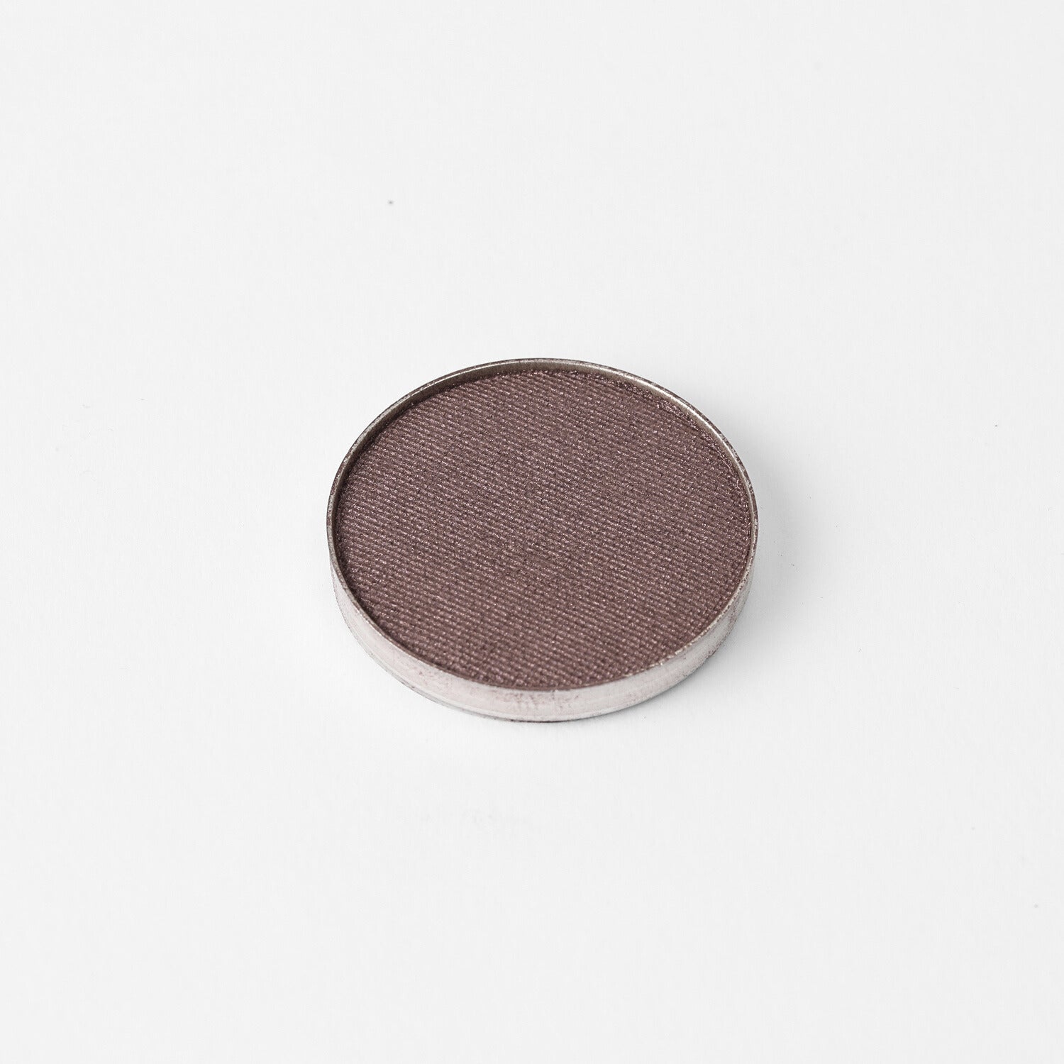 Glow Pressed Eyeshadow in a circular pan showcasing a rich vegan pigment with a smooth, blendable texture.