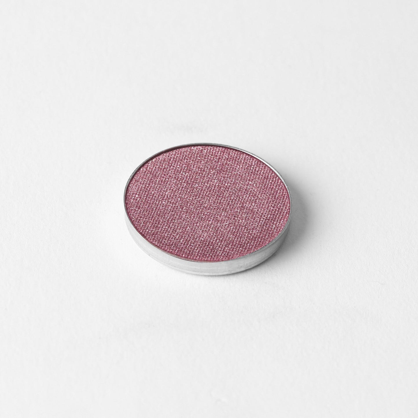 Glow Pressed Eyeshadow vegan shimmering Pink shade in a pan on white background