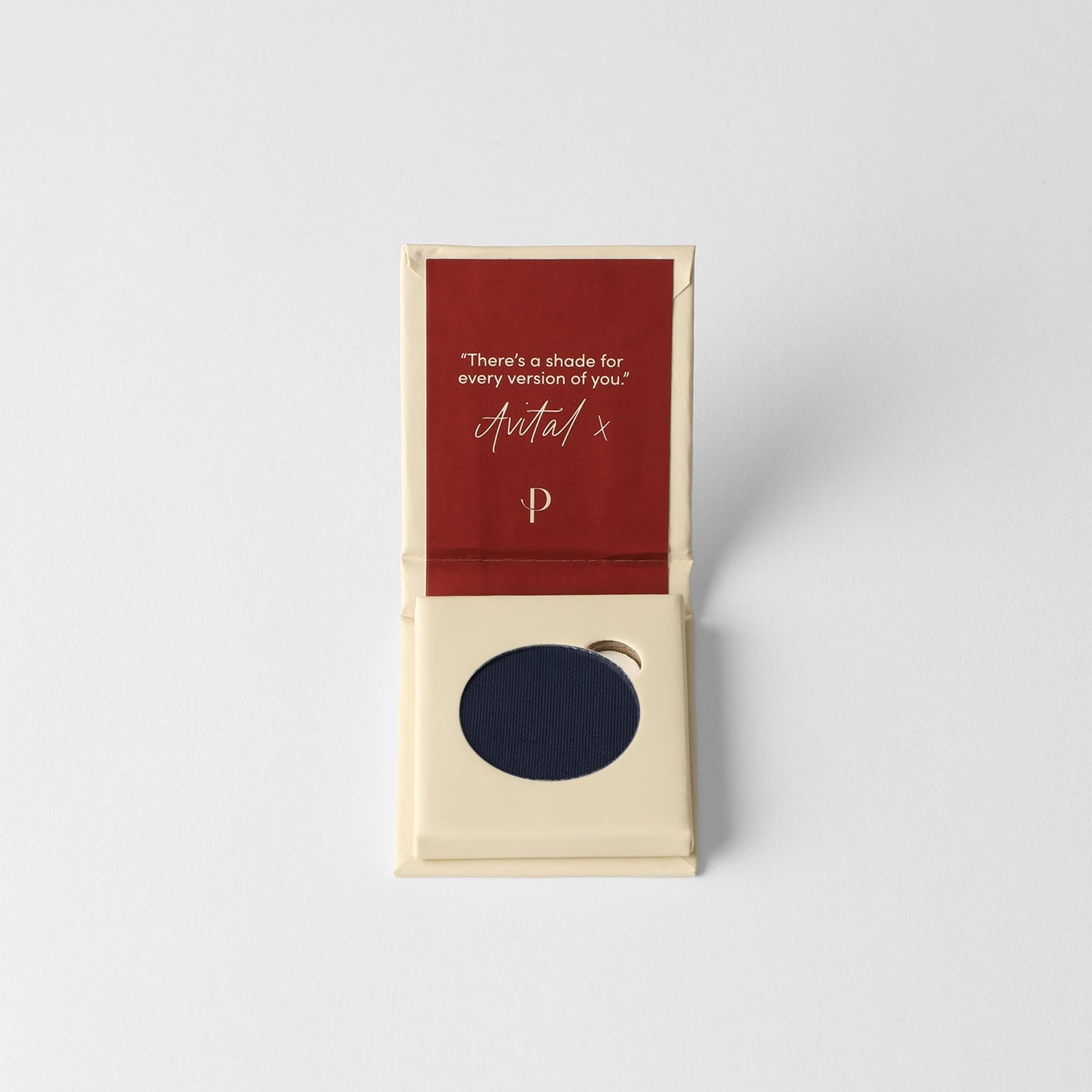 Matte Pressed Eyeshadow in dark blue shade with packaging featuring inspirational text. Ideal for seamless blending and buildable looks.