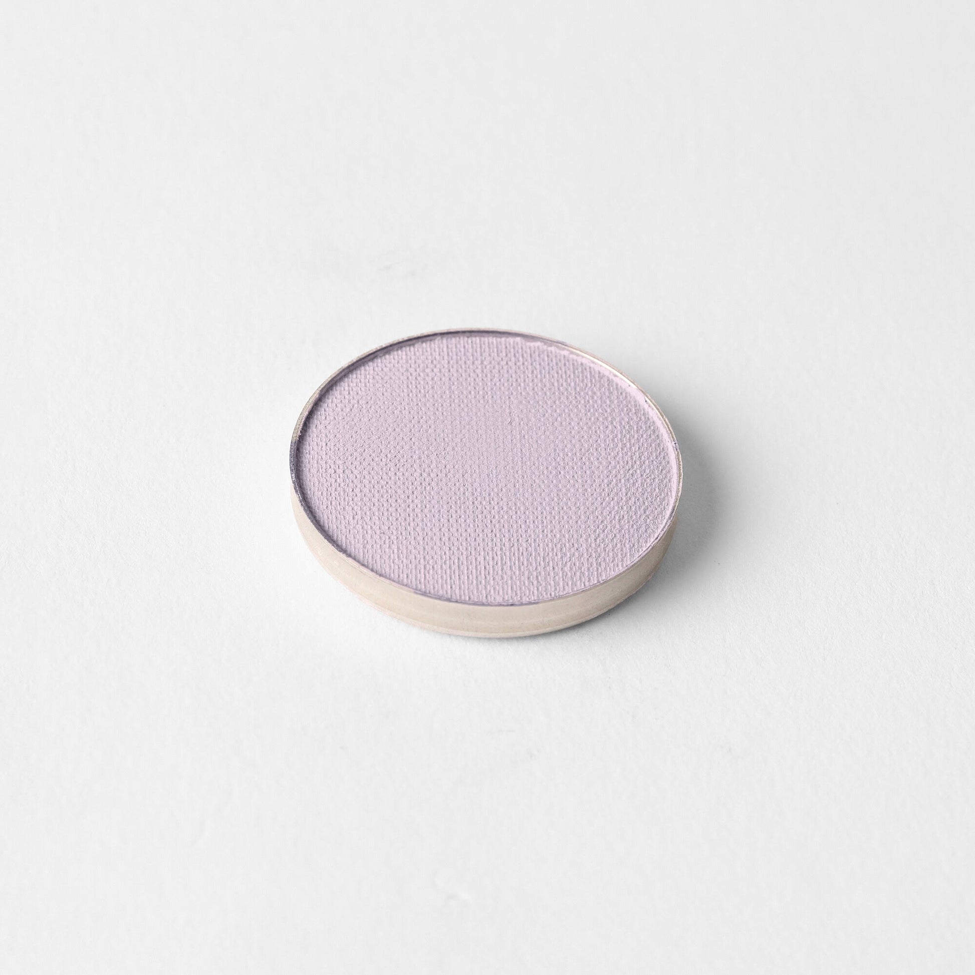 Matte Pressed Eyeshadow in a round pan against a white background, showcasing smooth, blendable, vegan pigment.