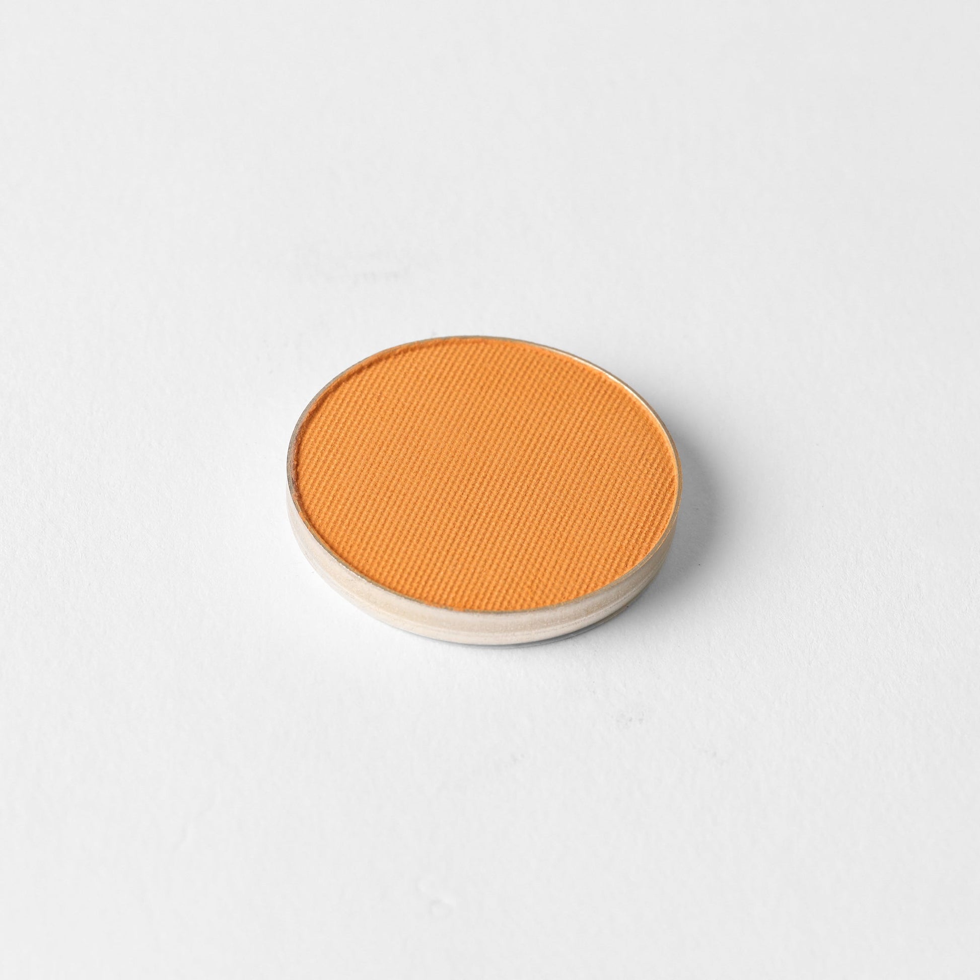 Matte Pressed Eyeshadow in a vibrant shade, shown in a removable pan for magnetic palettes. Ideal for natural or defined eye makeup looks.