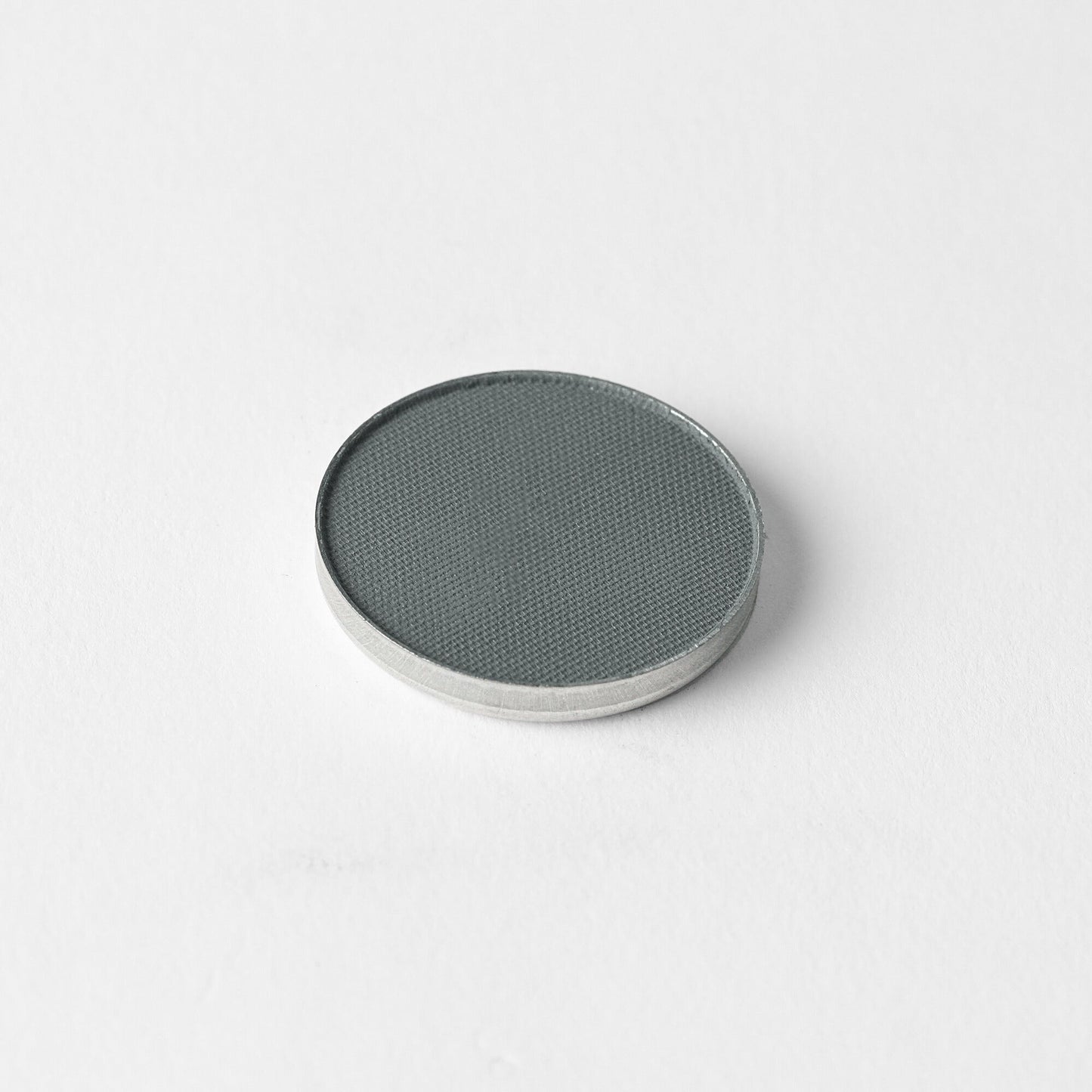 Matte Pressed Eyeshadow pan in a versatile gray shade for smooth application.