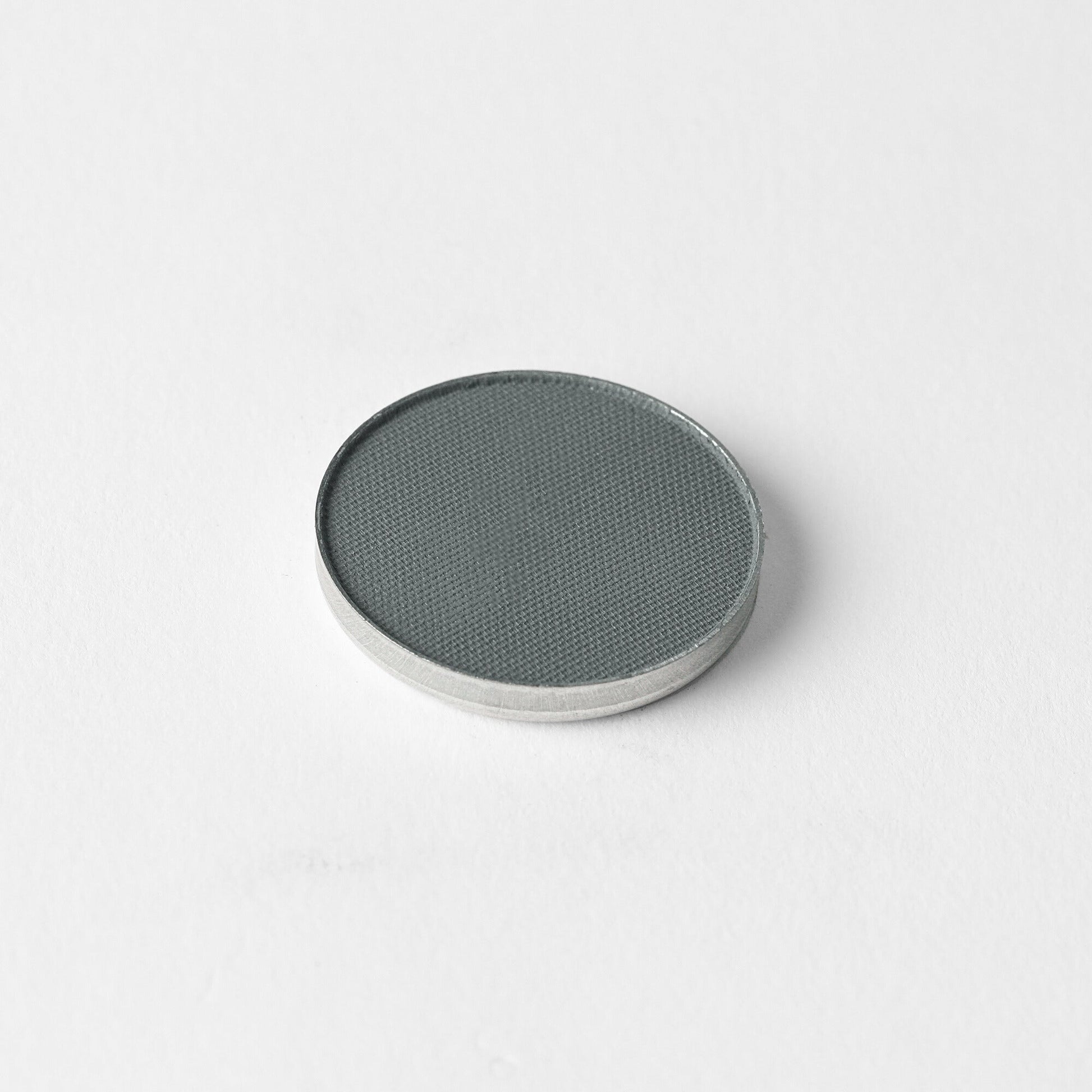 Matte Pressed Eyeshadow pan in a versatile gray shade for smooth application.