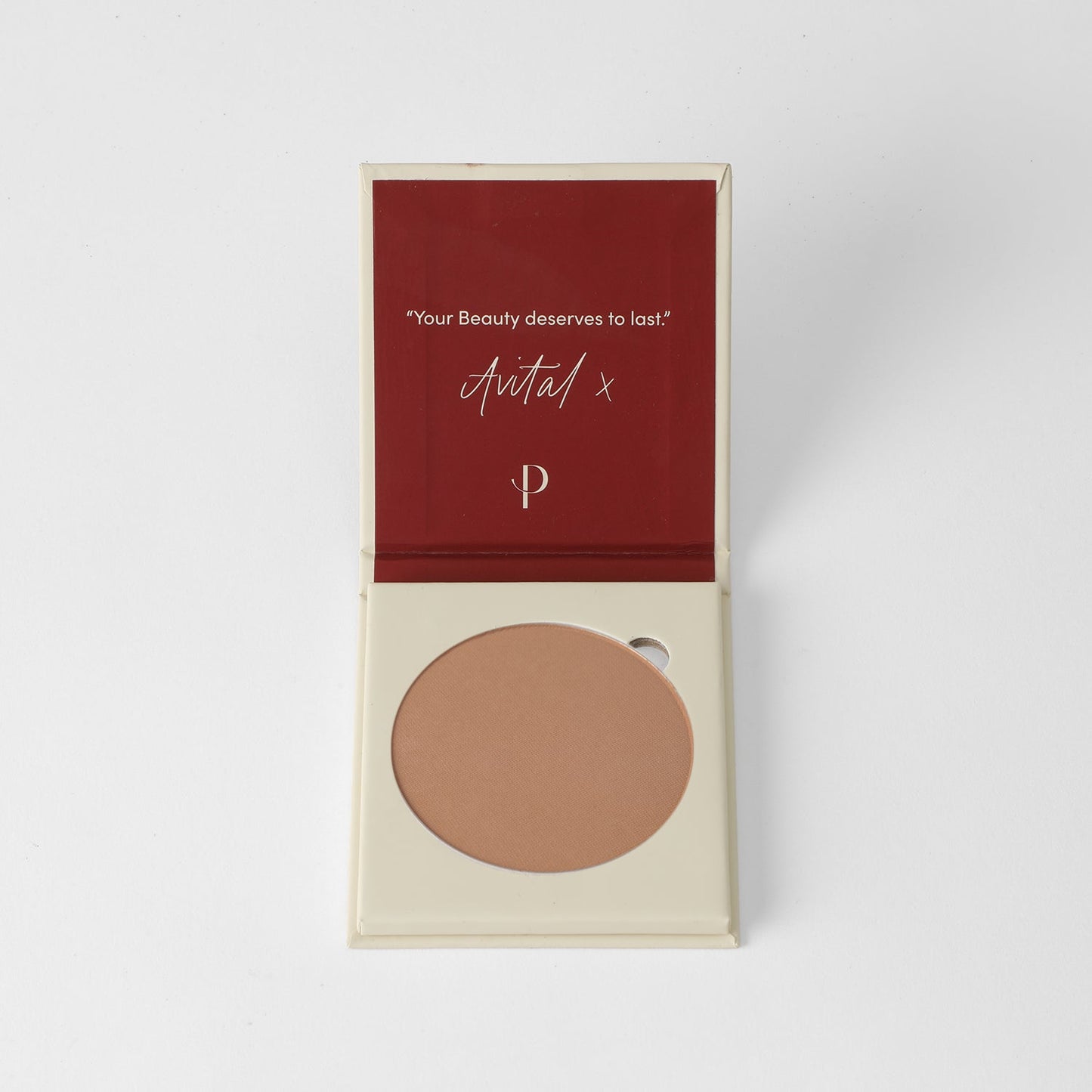 Open compact with vegan Face Powder and branded message on inner lid.