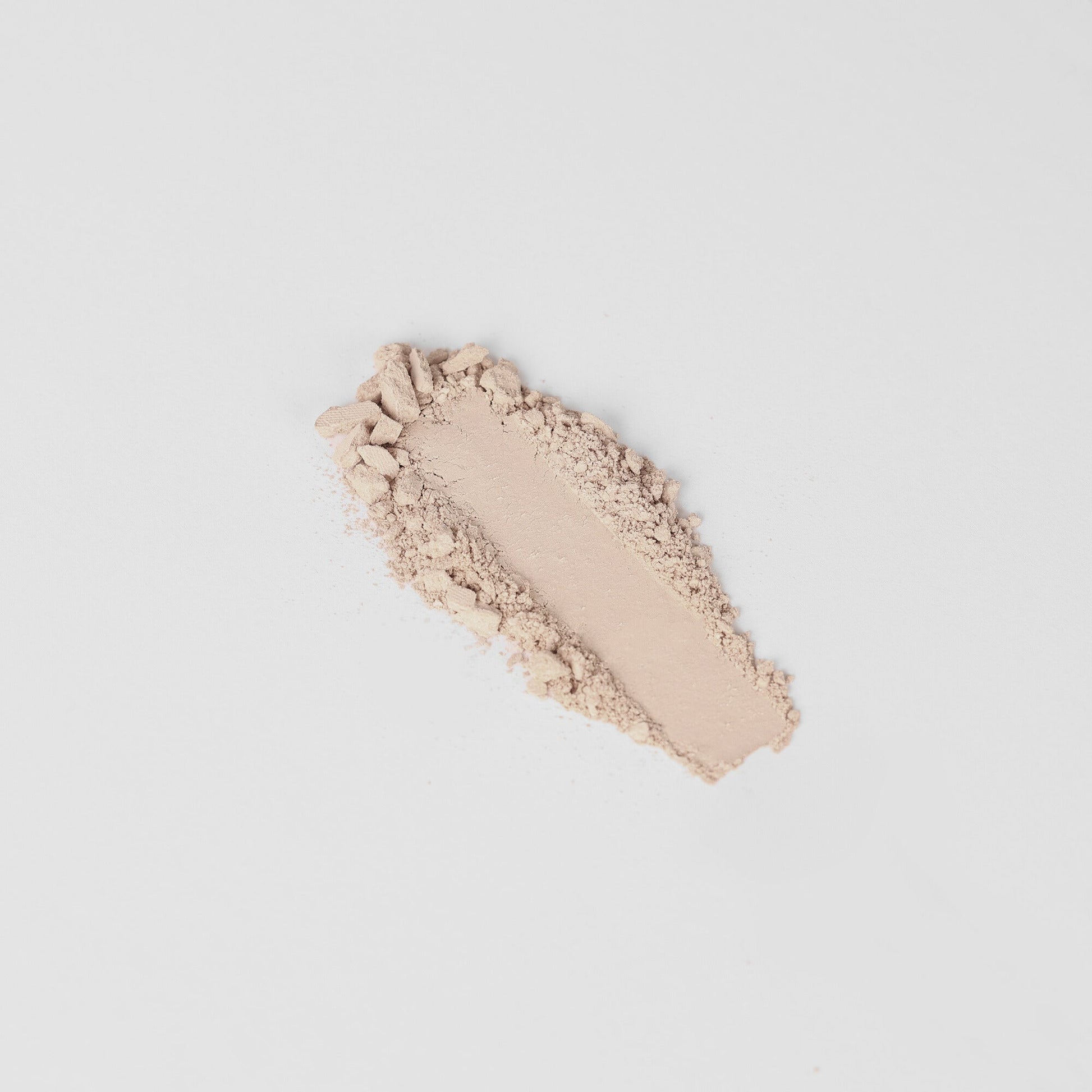 Textured swatch of vegan Highlighter in a glow finish on a white background.