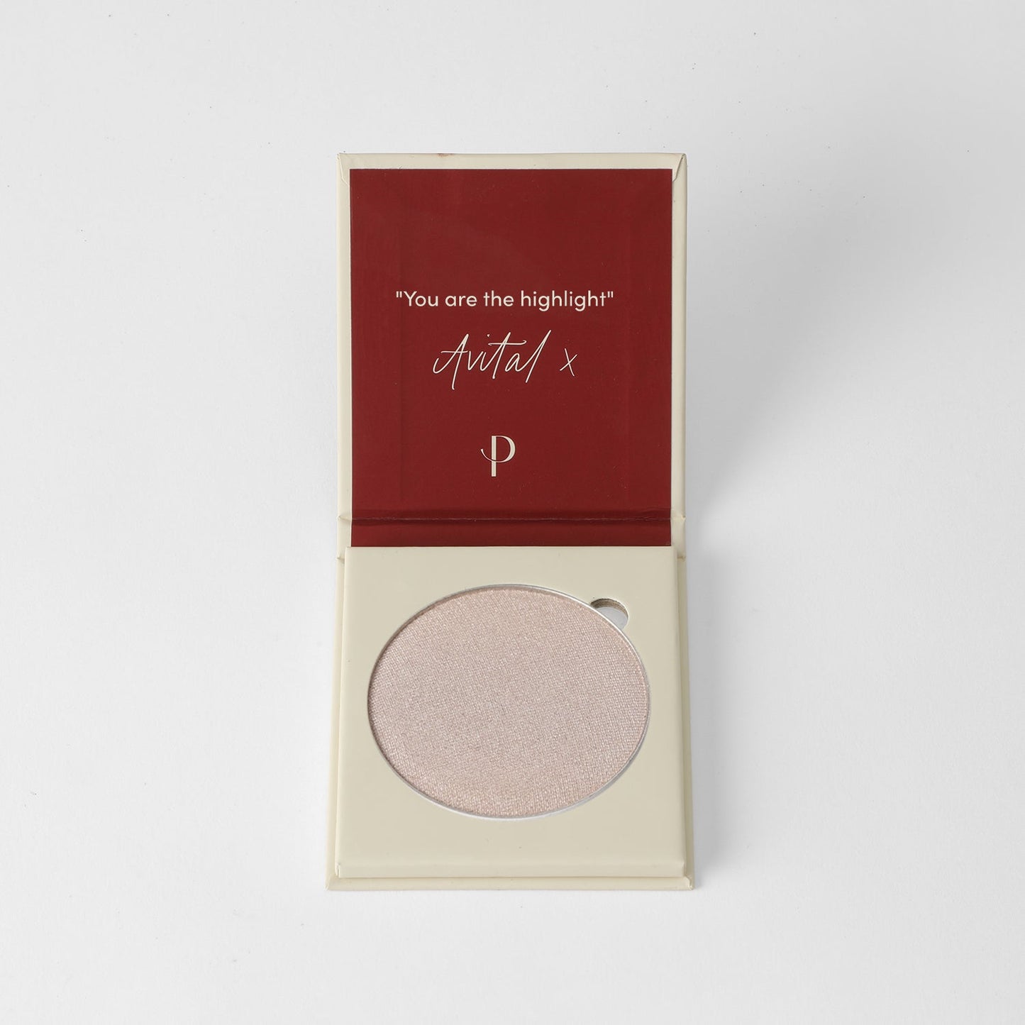 Highlighter pan in beige open compact with maroon inside lid, featuring smooth finish for customizable glow or matte looks.