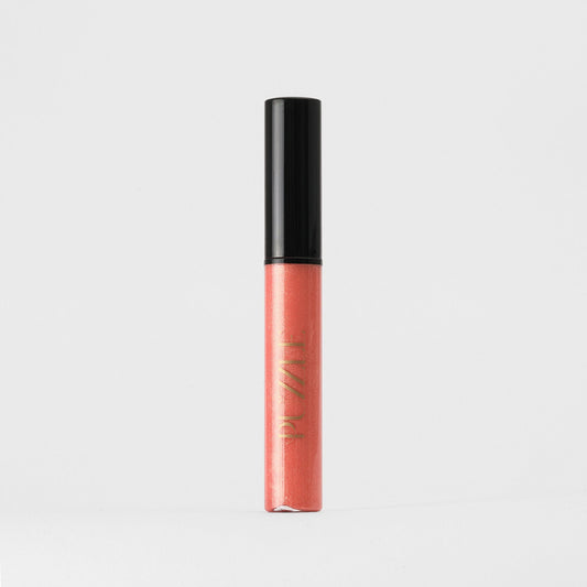 Lip Gloss Wand in coral hue, vegan gloss for a dimensional glow and smooth, nourished lips; ideal for solo wear or layering.