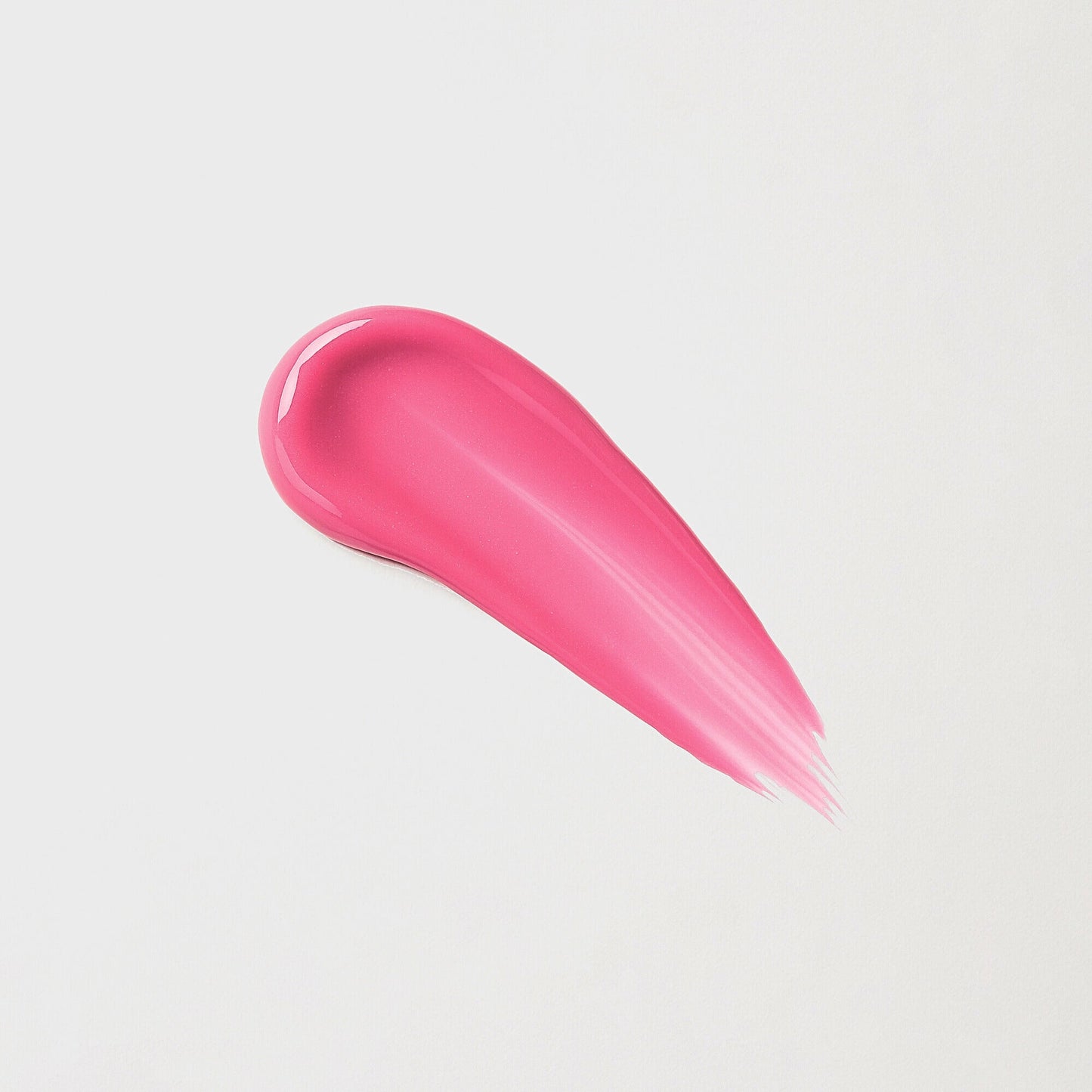 Swatch of pink Lip Gloss Wand showcasing a soft-touch, high-shine finish on a white background.