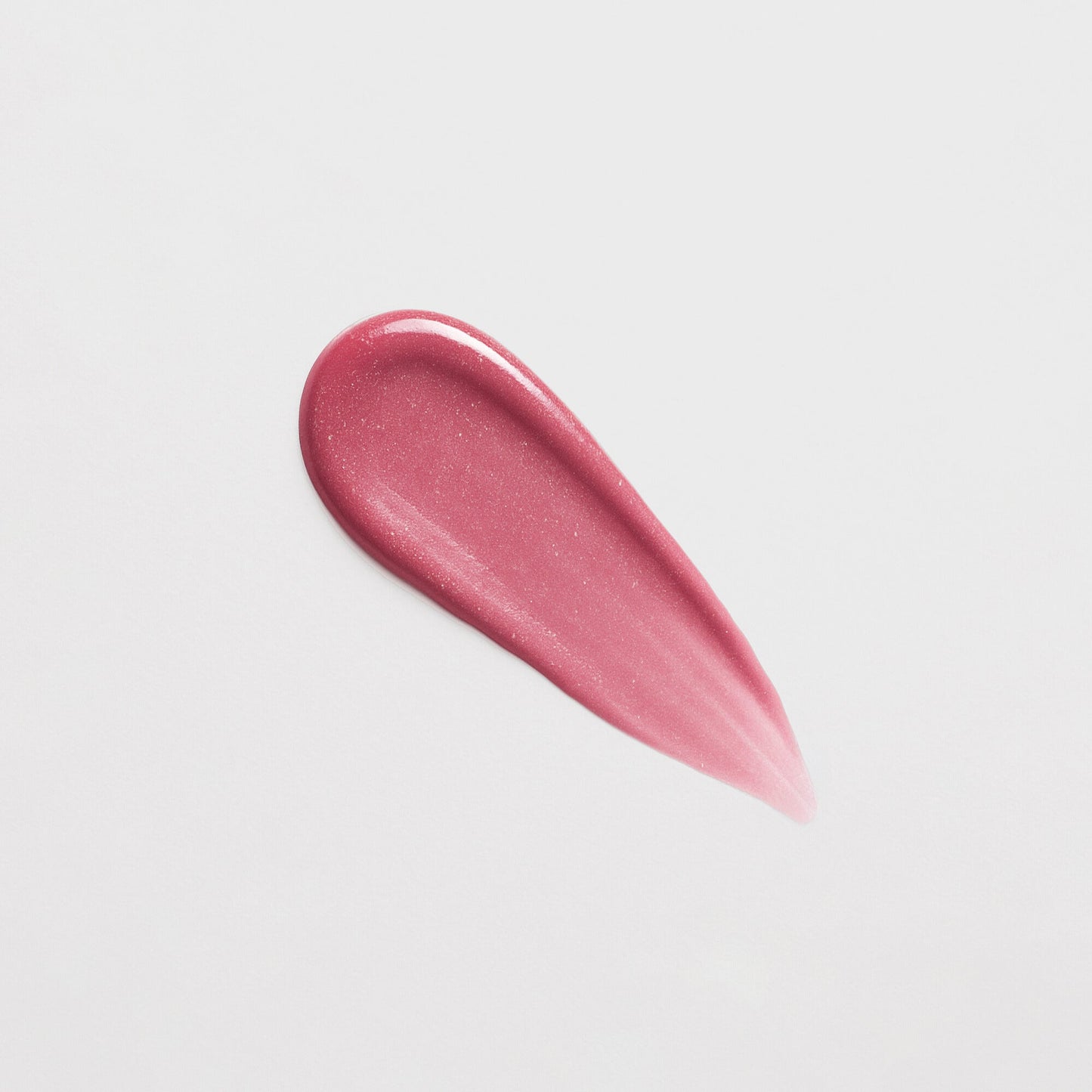 Pink Lip Gloss Wand swatch showcasing a soft-touch, high-shine finish, perfect for adding a vegan glow to hydrated lips.