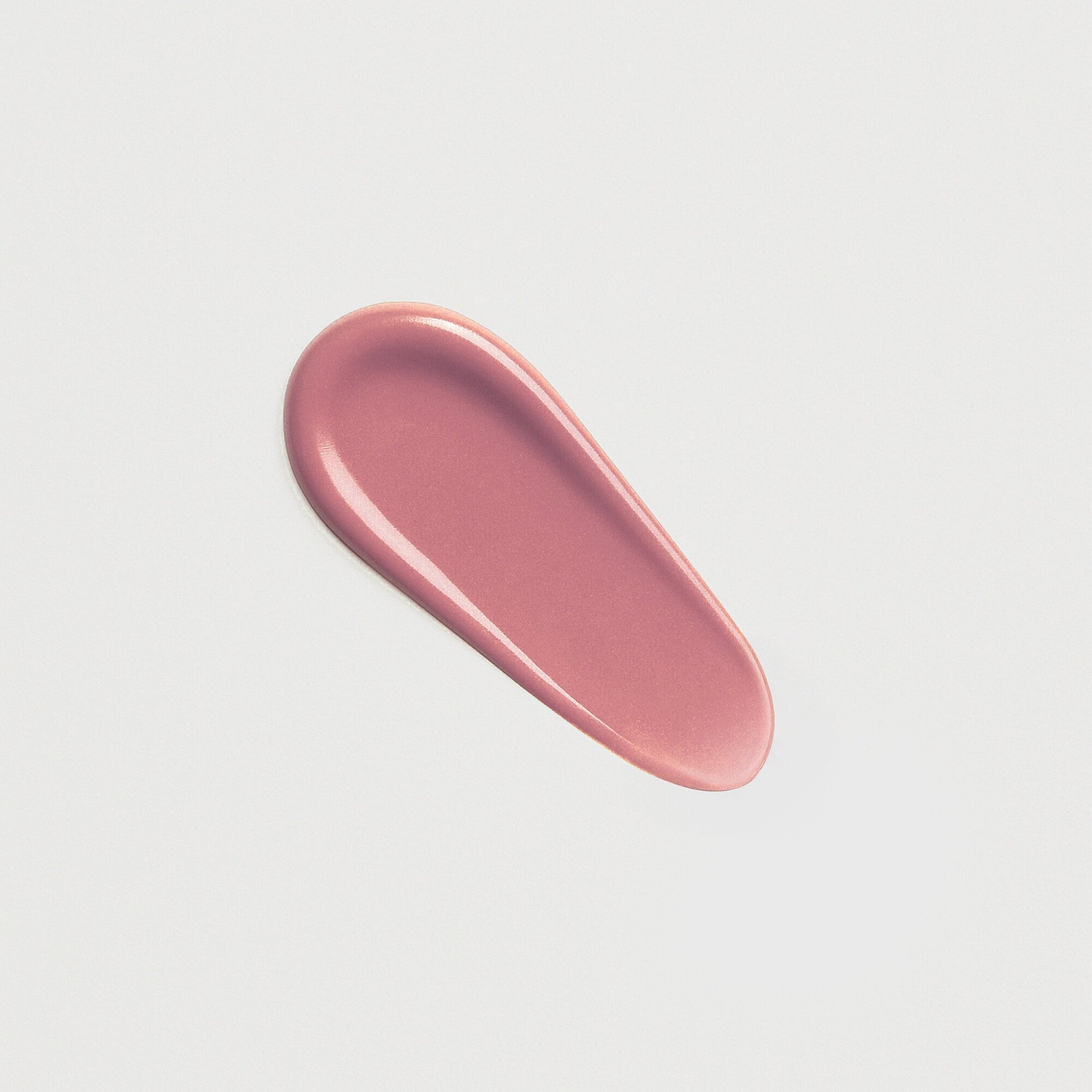 Pink Lip Gloss Wand smear showing soft, high-shine texture, perfect for a dimensional glow and smooth, nourished lips.