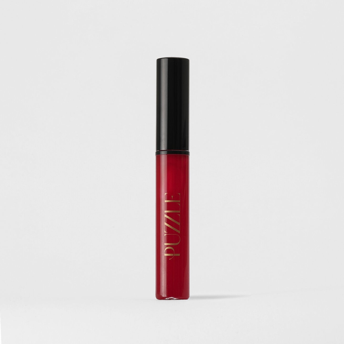 Lip Gloss Wand in a red tube with a black cap, offering a soft-touch, high-shine, vegan formula for nourished lips.