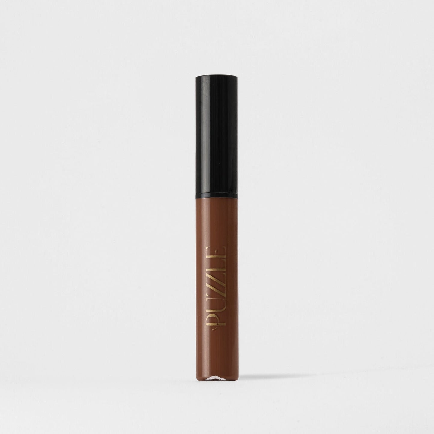 Lip Gloss Wand in brown shade with a sleek black cap, offers a high-shine, vegan formula for nourished, smooth lips.