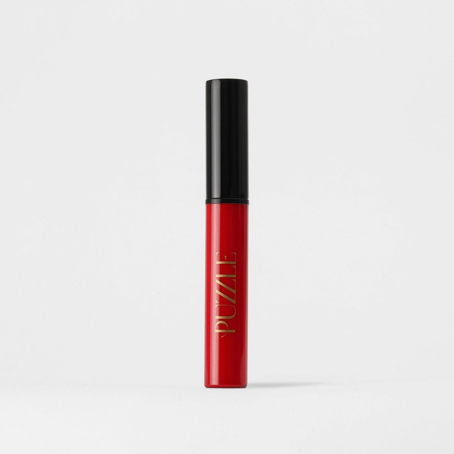 Lip Stain in red tube with black cap, showcasing vegan, velvety-soft formula for long-lasting matte coverage and skin benefits.