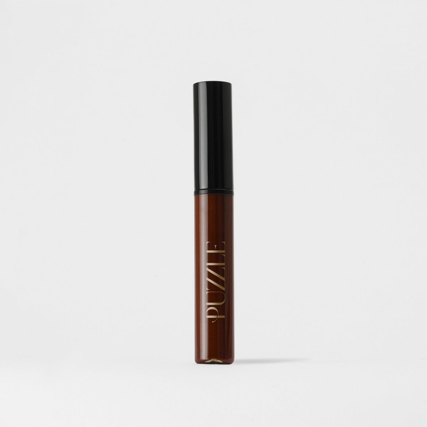 Lip Stain in brown tube with black cap, offering vegan, velvety-soft formula for matte finish and lasting coverage, enhances lip appearance.