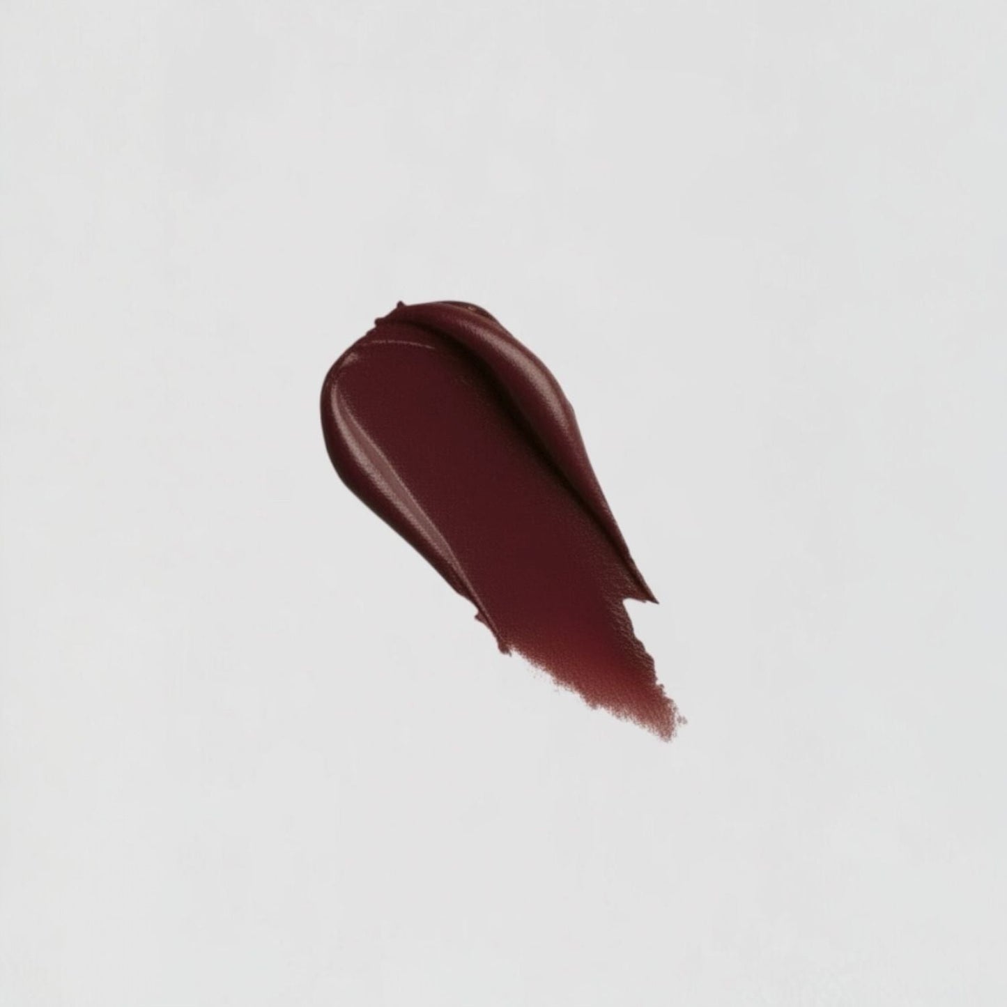 Rich burgundy Lip Stain swatch showing matte velvety texture and long-lasting vegan formula for soft, plush lips.