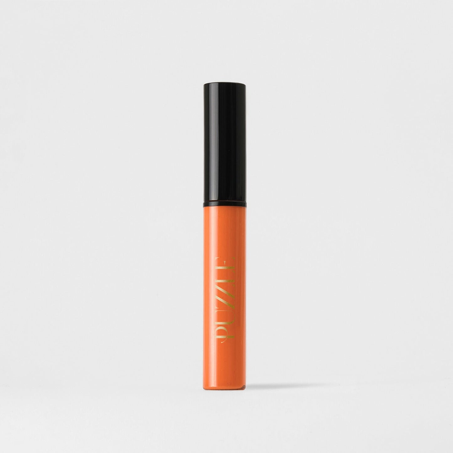 Vegan Lip Stain in orange, velvety-soft, matte finish with long-lasting coverage, tube standing upright on a white background.