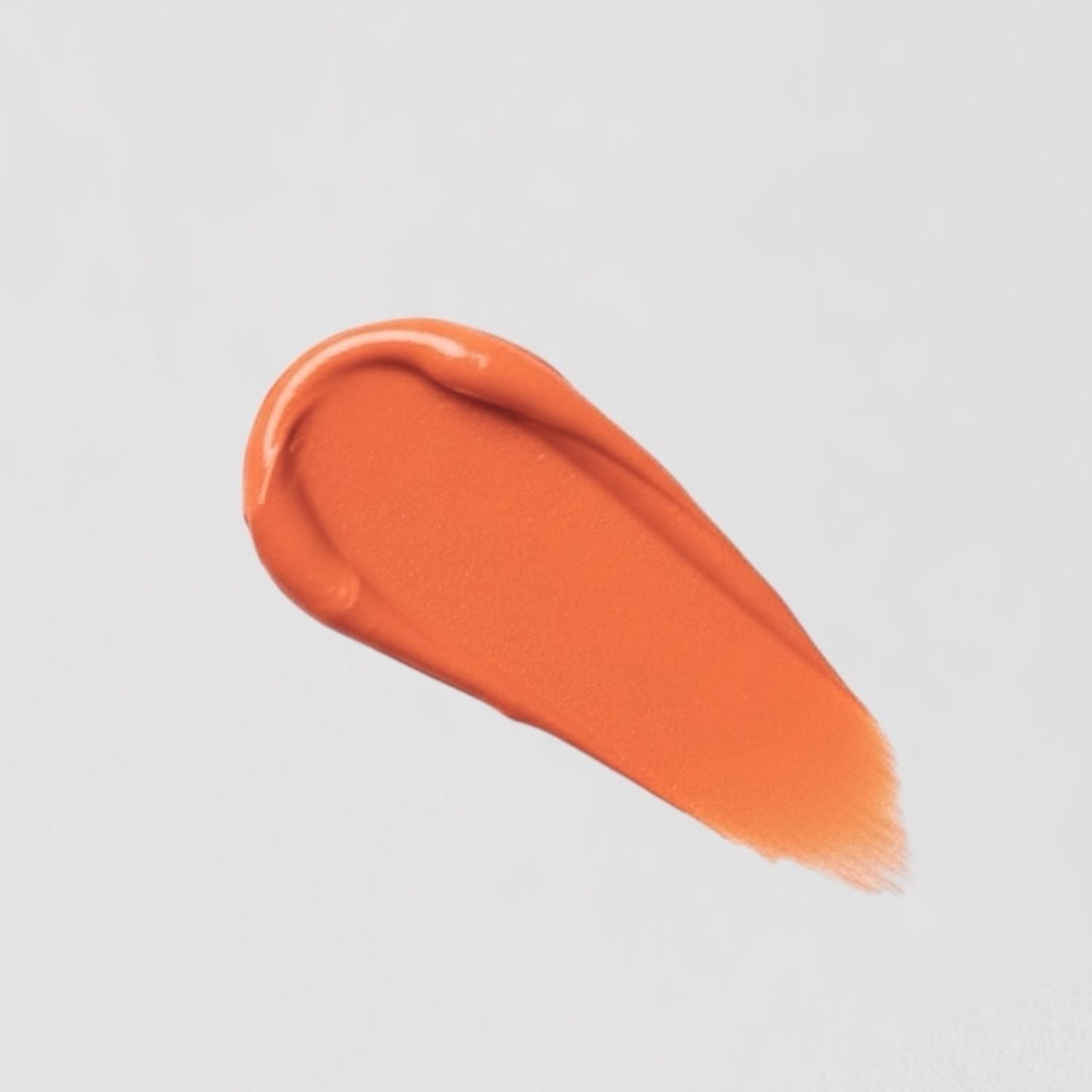 Orange vegan Lip Stain swatch on a white background, showcasing matte coverage and velvety texture.