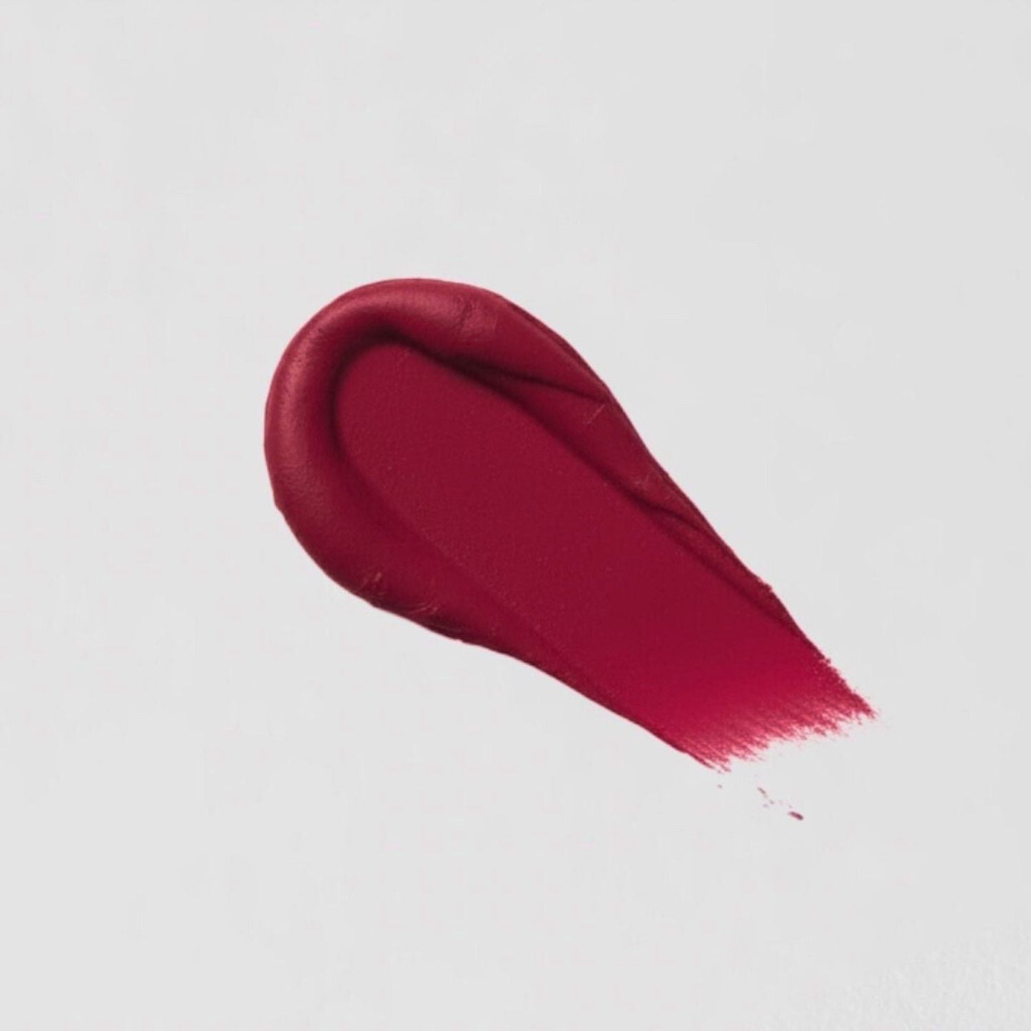 Lip Stain swatch showcasing vibrant, velvety red shade with matte finish, highlighting vegan formula and long-lasting wear.