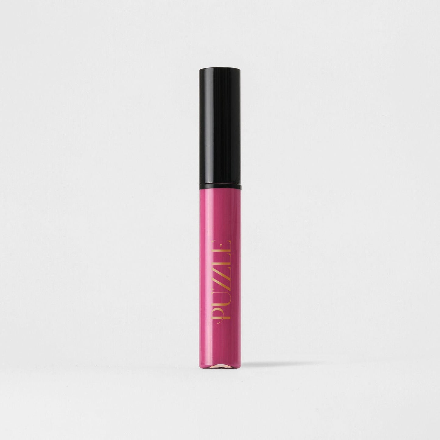 Bright pink Lip Stain tube with black cap, offering velvety matte finish and lasting coverage. Vegan and skin-friendly formula.