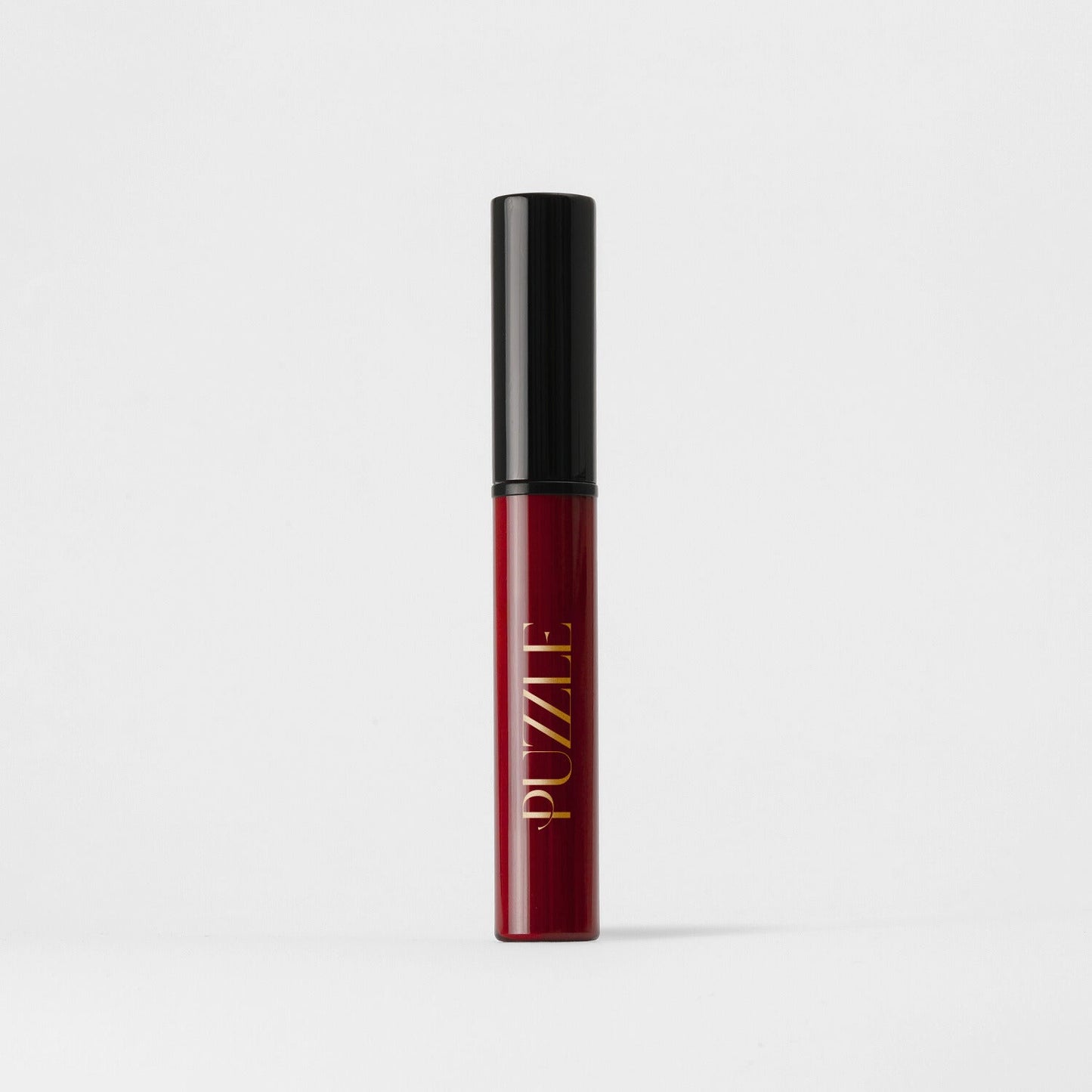 Lip Stain in a sleek red tube with black cap, offering vegan matte coverage and skin benefits.