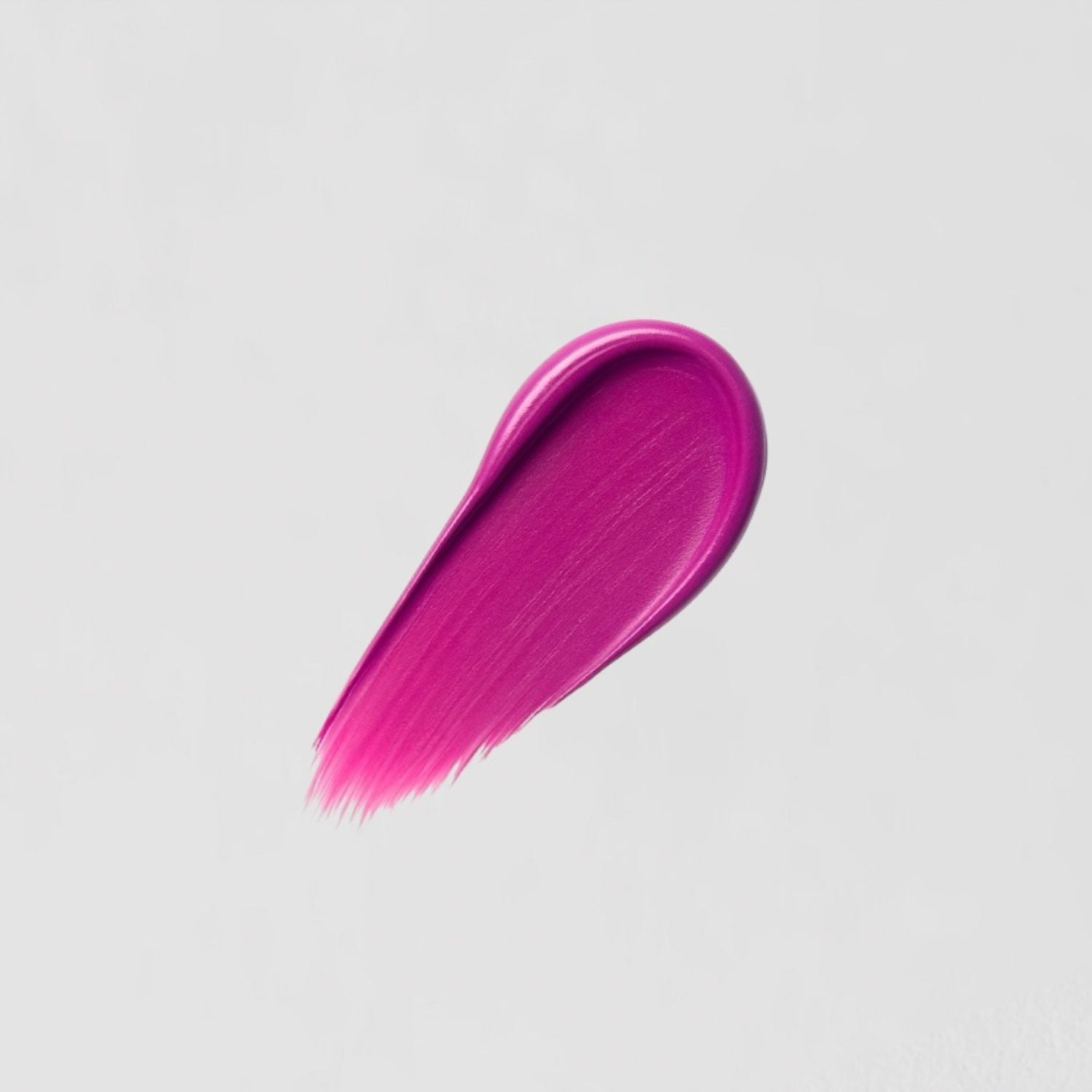Swipe of vibrant pink Satin Lipstick with creamy, full-coverage formula and satin sheen on white background.