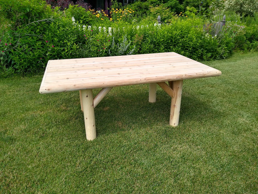 Rustic Outdoor Wooden Patio Table in a garden setting, showcasing its handcrafted white cedar design and weather-resistant durability.