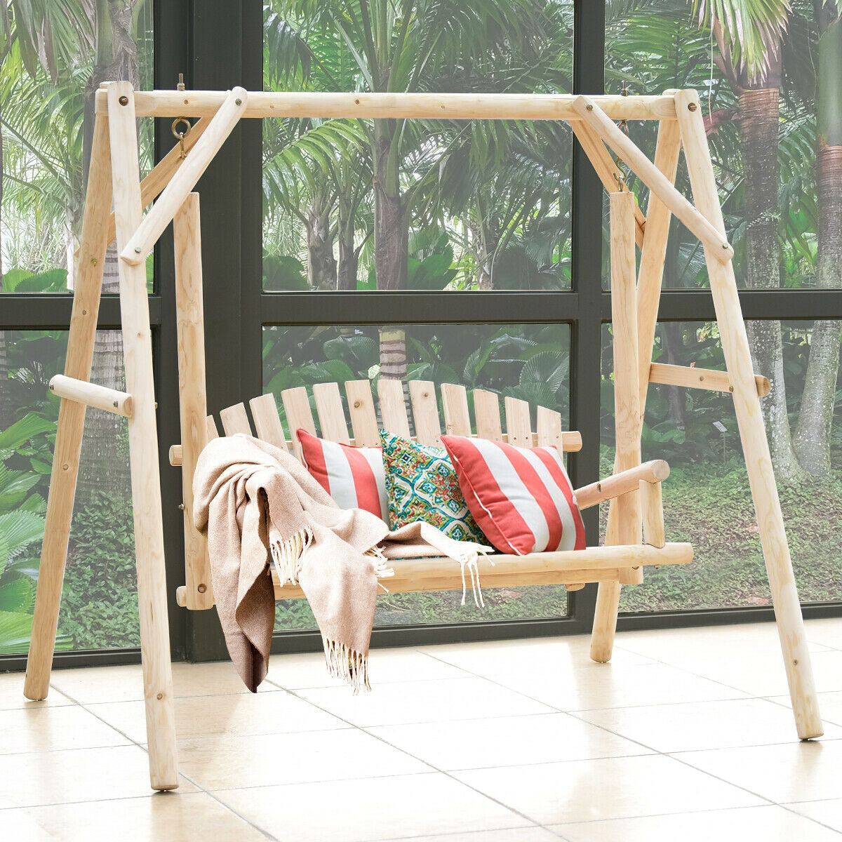 Outdoor Wooden Porch Bench Swing Chair with Rustic Curved Back on a patio with cushions and a blanket