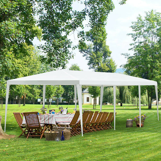 10 x 30 Feet Gazebo Canopy Tent with Connection Stakes and Wind Ropes set up in a garden with chairs and dining table underneath.