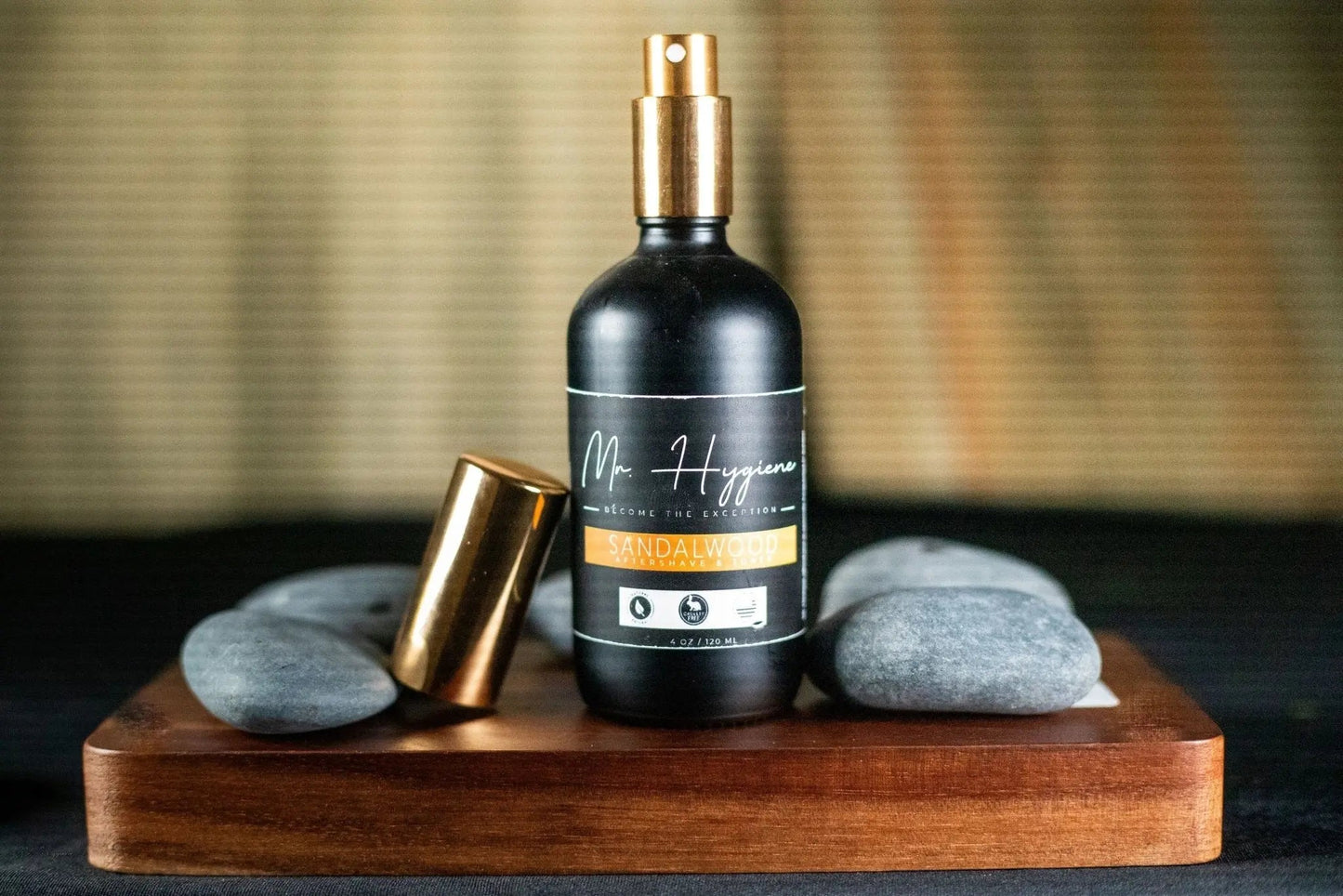 Sandalwood Aftershave & Toner bottle on wooden tray with stones, promoting skin nourishment and hydration.