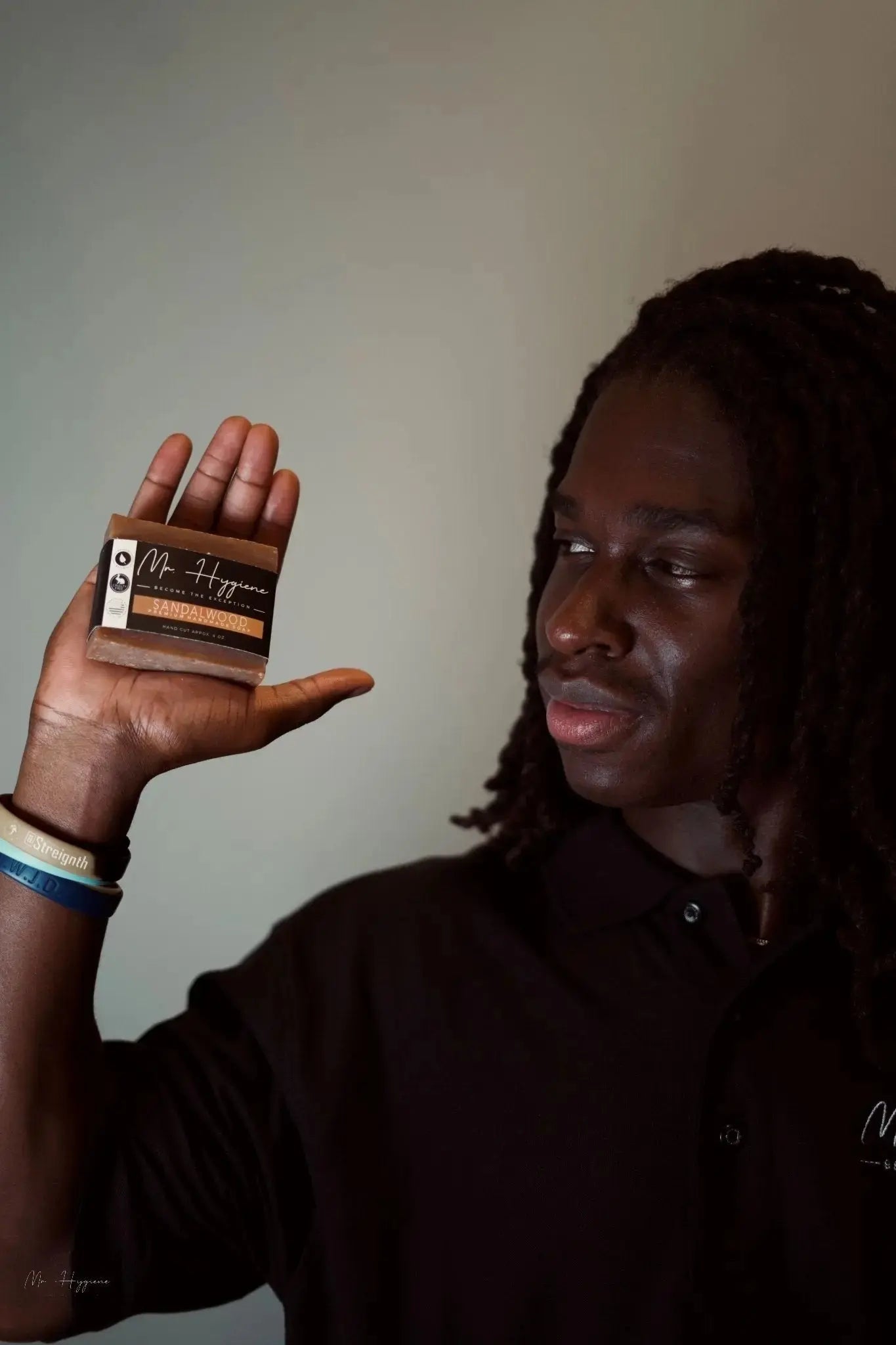 Man holding Sandalwood Bar Soap – Classic Scent, Deep Clean, showcasing its packaging for effective and eco-friendly grooming.