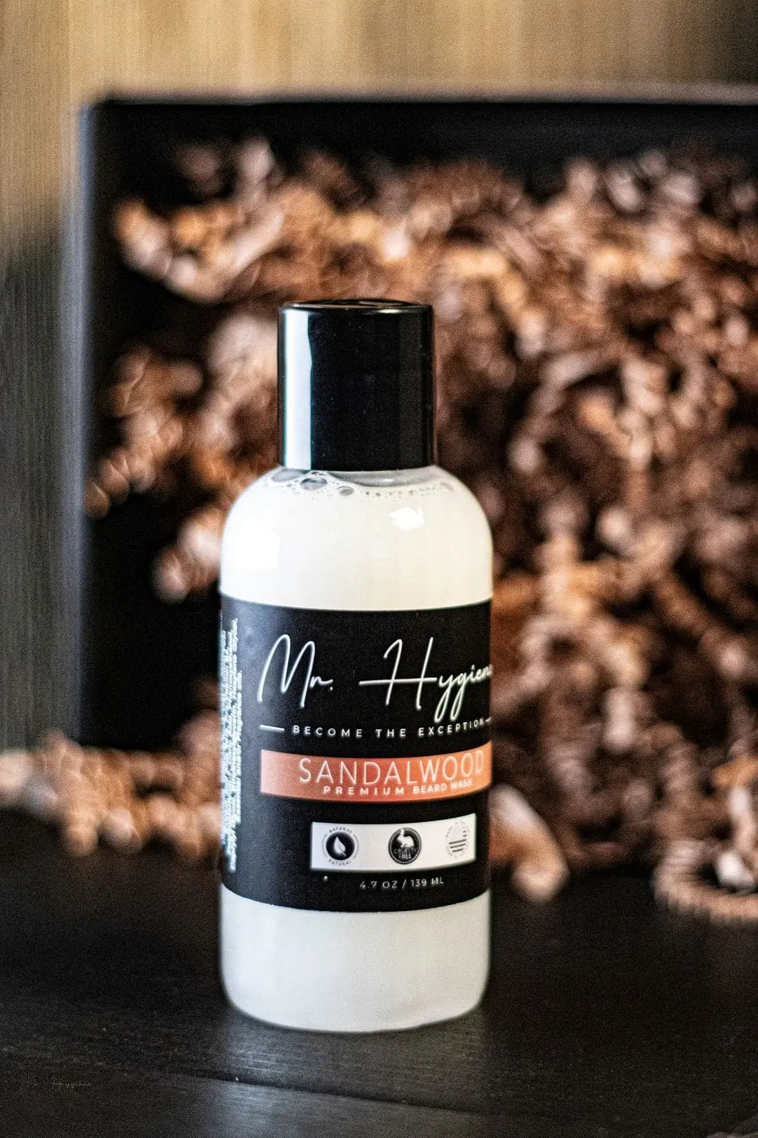 Sandalwood Beard Wash & Conditioner bottle displayed on a table, ideal for cleansing and hydrating men's beards with a soothing sandalwood scent.