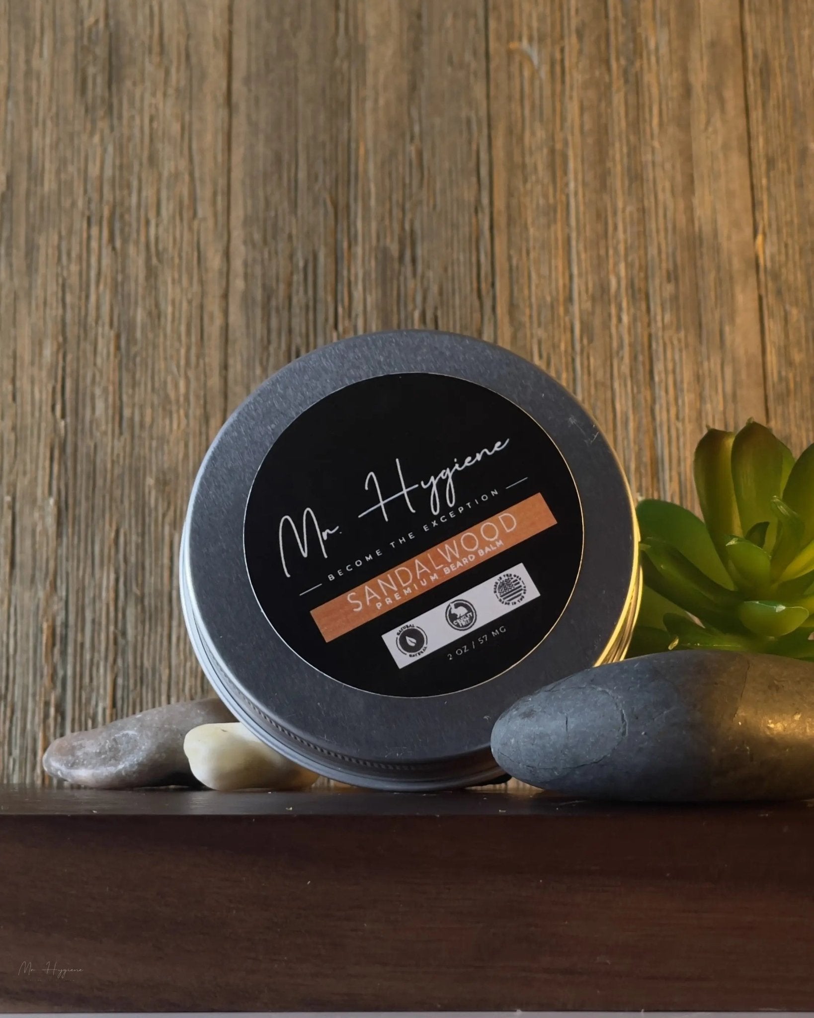 Sandalwood Beard Balm for Men – Shape, Soften & Scent in a tin on a wooden surface with decorative stones