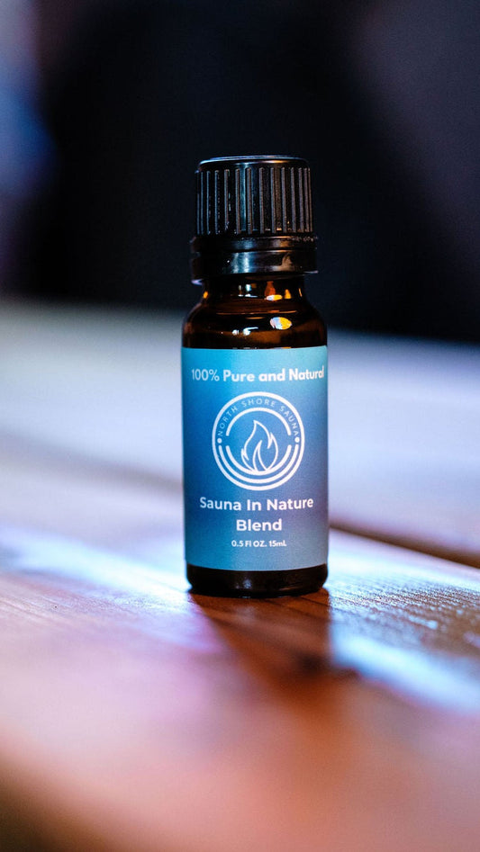 Essential Oil Blend | Sauna In Nature bottle on a wooden surface, perfect for aromatherapy in sauna sessions with eucalyptus and cedarwood.