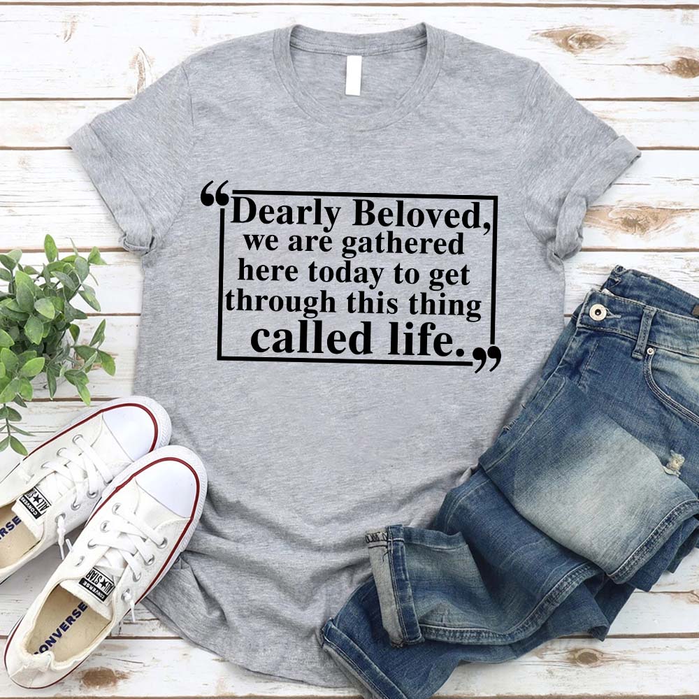 Dearly Beloved Tee Unisex Funny Quote Shirt with sneakers and jeans on a wooden background