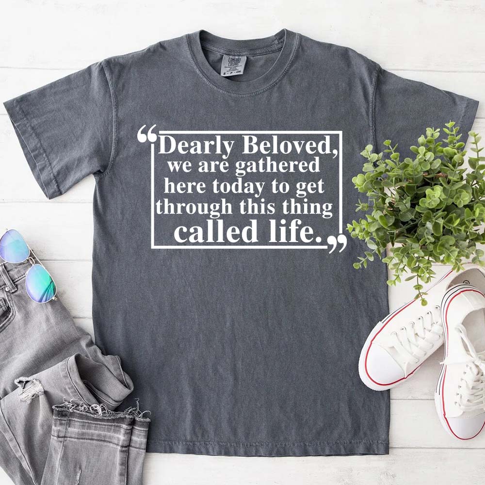 Dearly Beloved Tee Unisex Funny Quote Shirt on display with casual accessories.