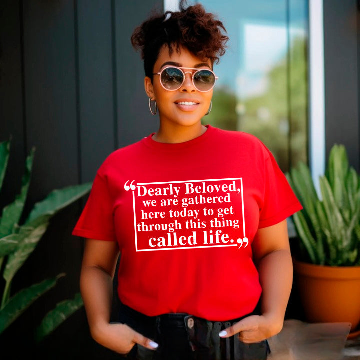 Woman wearing Dearly Beloved Tee Unisex Funny Quote Shirt, red with white text, casual style outdoors