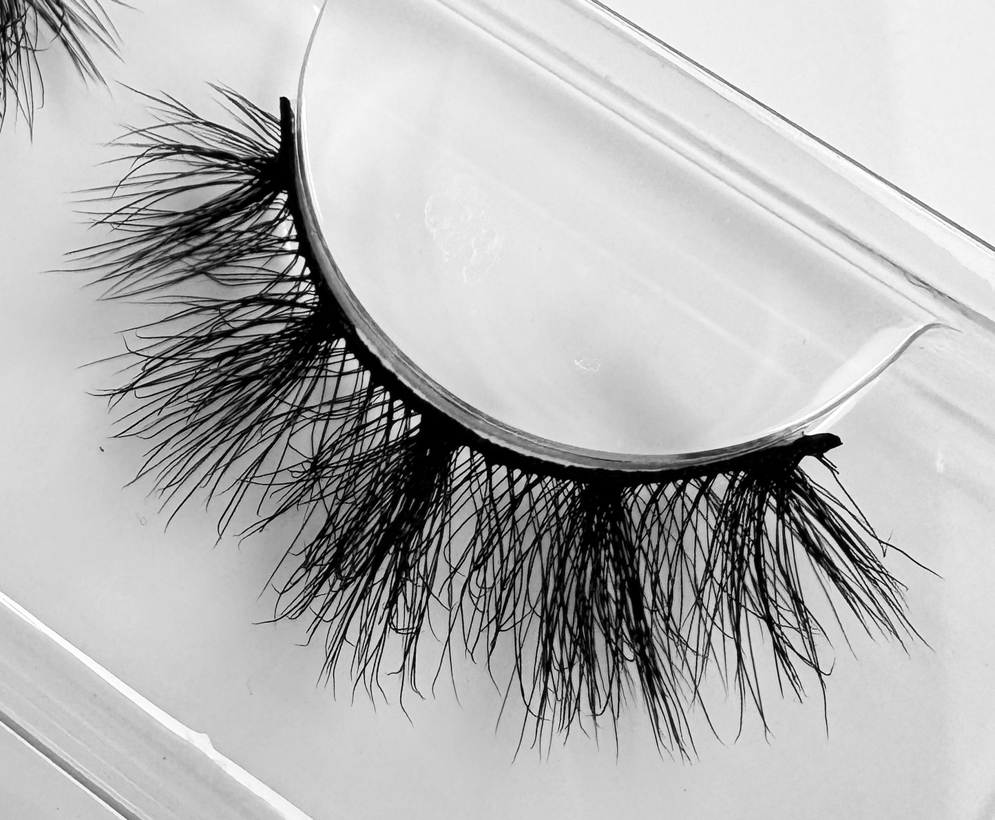 Spell faux mink false eyelashes, vegan and cruelty-free, featuring wispy and fluffy design with a flexible band, easy to apply.