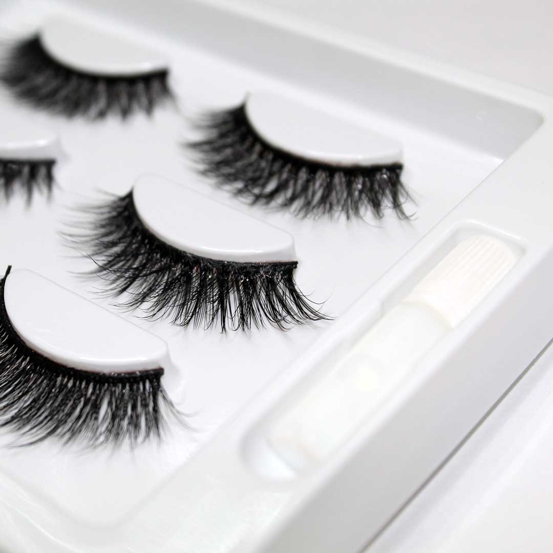 The Threesome | 3 Way Strip Lash Set in packaging with dramatic styles of reusable false lashes and glue for billion dollar blinks.