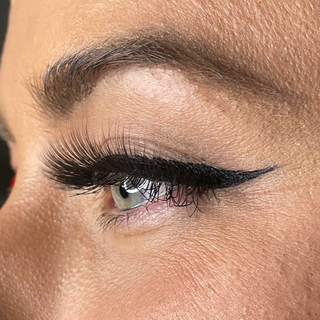 Close-up of eye wearing The Threesome | 3 Way Strip Lash Set for dramatic lashes.